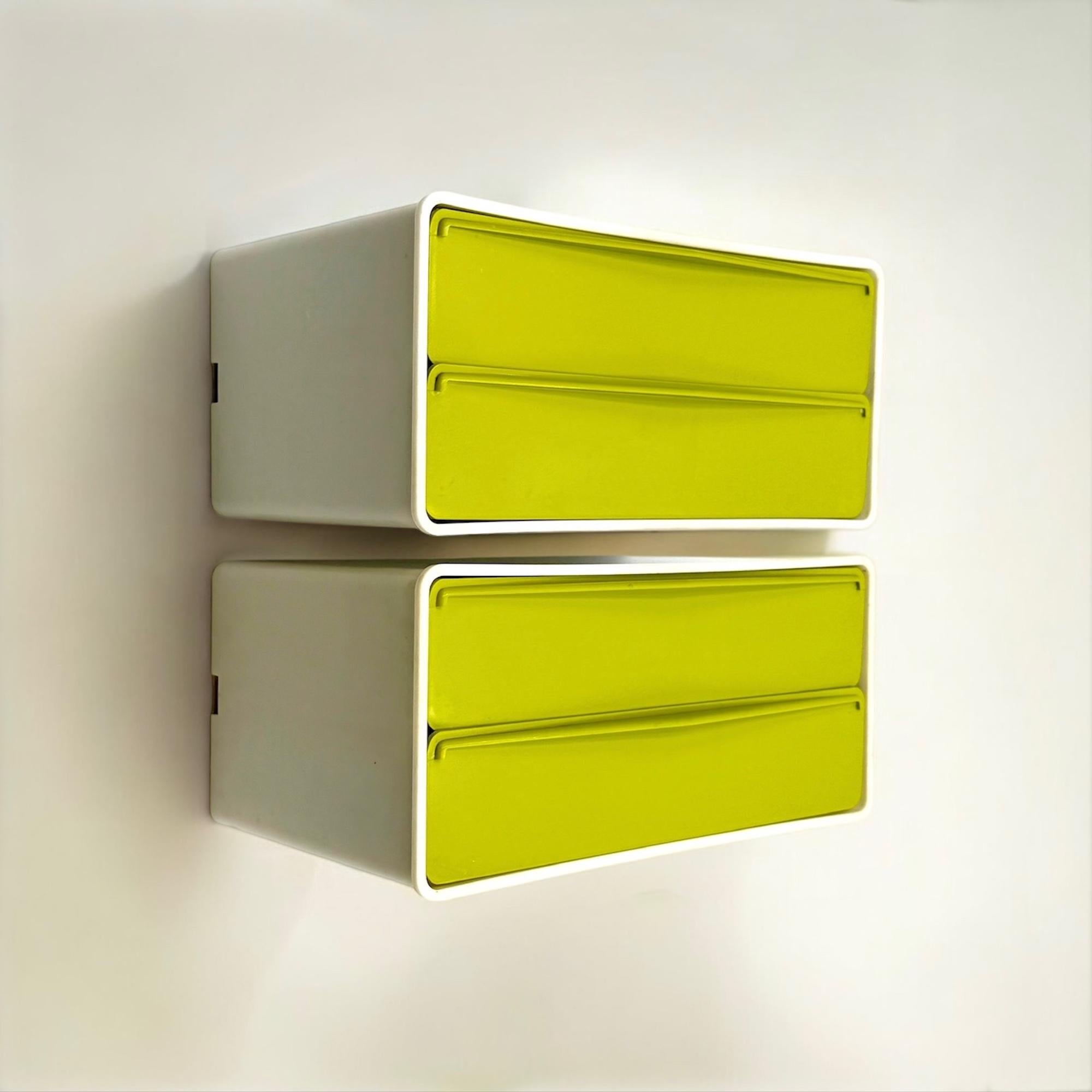 Rare set of two 70s wall units, attributed to the brand Flair.

Designed for versatility, these compact drawer units can be mounted on the wall or used as tabletop organizers. The ivory plastic structure contrasts strikingly with the vibrant