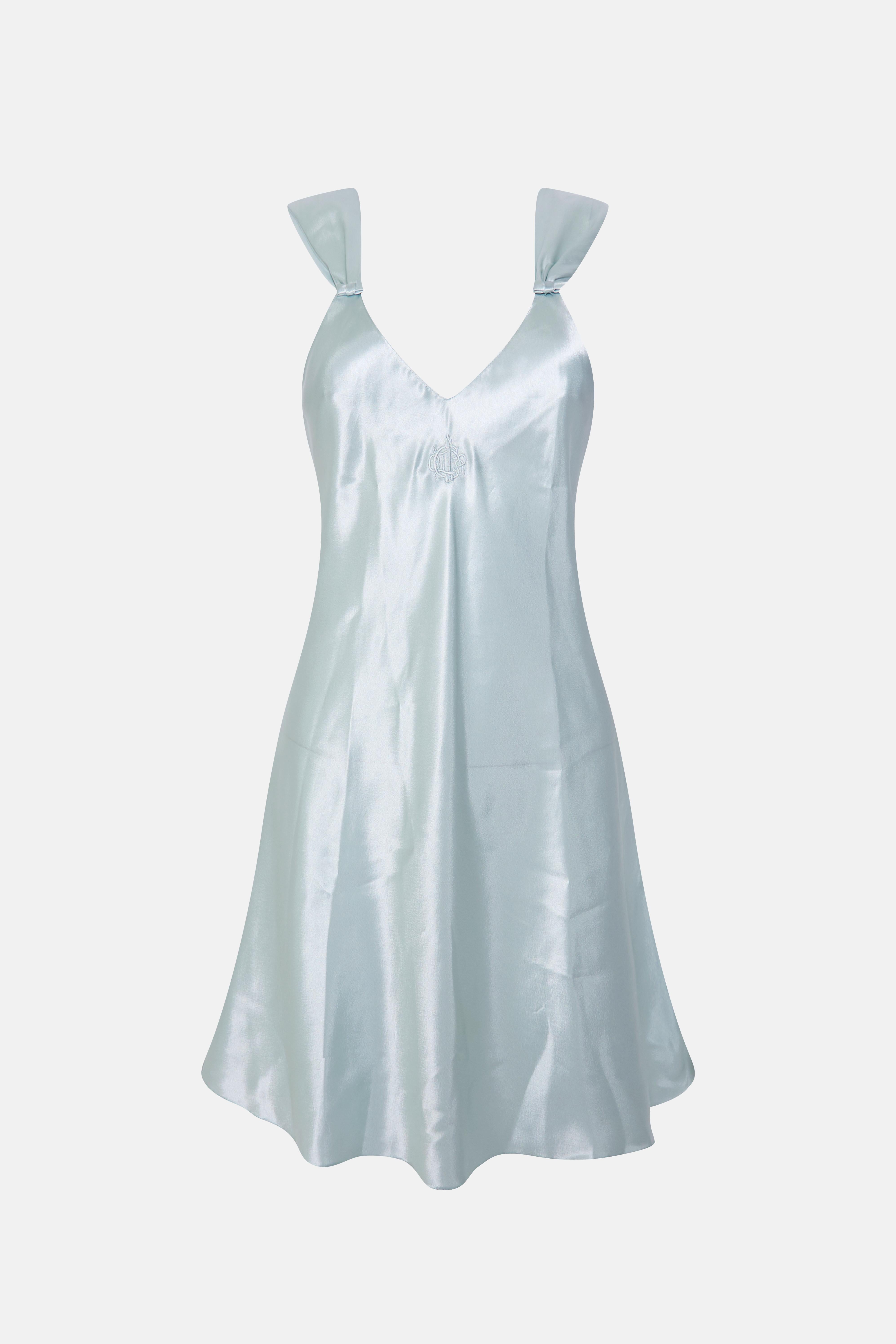 The dress features a classic baby doll silhouette, with a fitted bodice and a flowing, A-line skirt. The material is a gorgeous, shimmering blue that captures the glamour and elegance of the 70s era.

The dress is short in length, hitting around