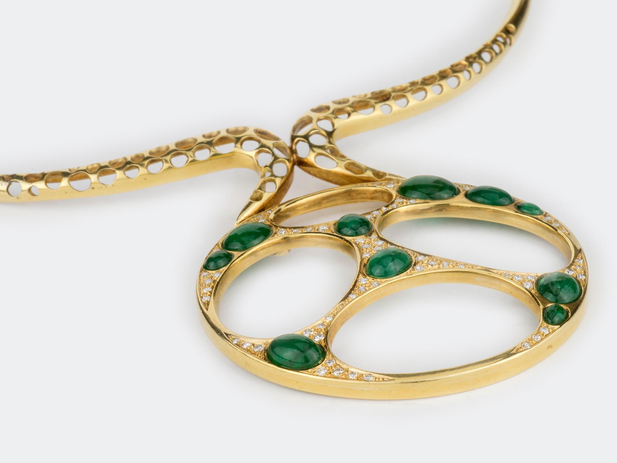 18k gold Torque Necklace suspending a round disc pendant set with cabochon emeralds.Emerald weight approximately 4.50 carats. Gold mark.