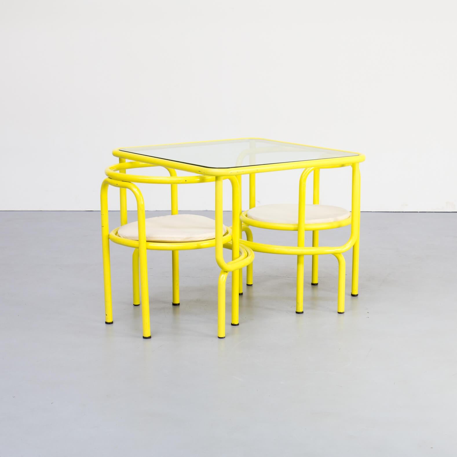 The Locus Solus collection became a distinctive icon of the time with its poolside presence in the film La Piscine, starring Alain Delon, Romy Schneider & Jane Birkin. This set of 1 table and 2 chairs is in good condition consistent with age and use.