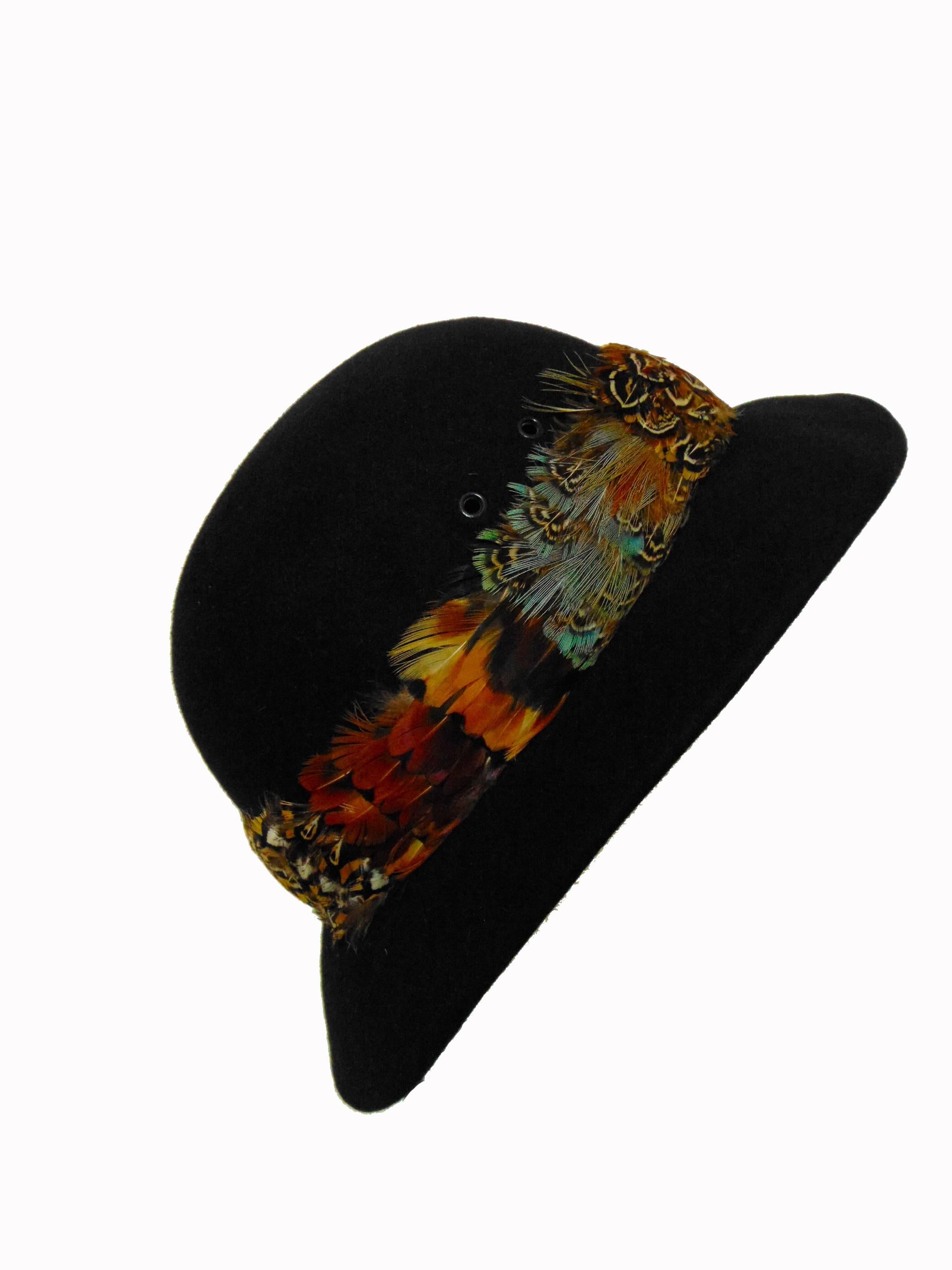 Here's a pretty wool felt hat with feather brim, made by Halston in the early 70s.  In excellent preowned condition with minimal signs of prior wear.  No size tag, but it measures appx 21 7/8 inches around, which is the equivalent of a modern size