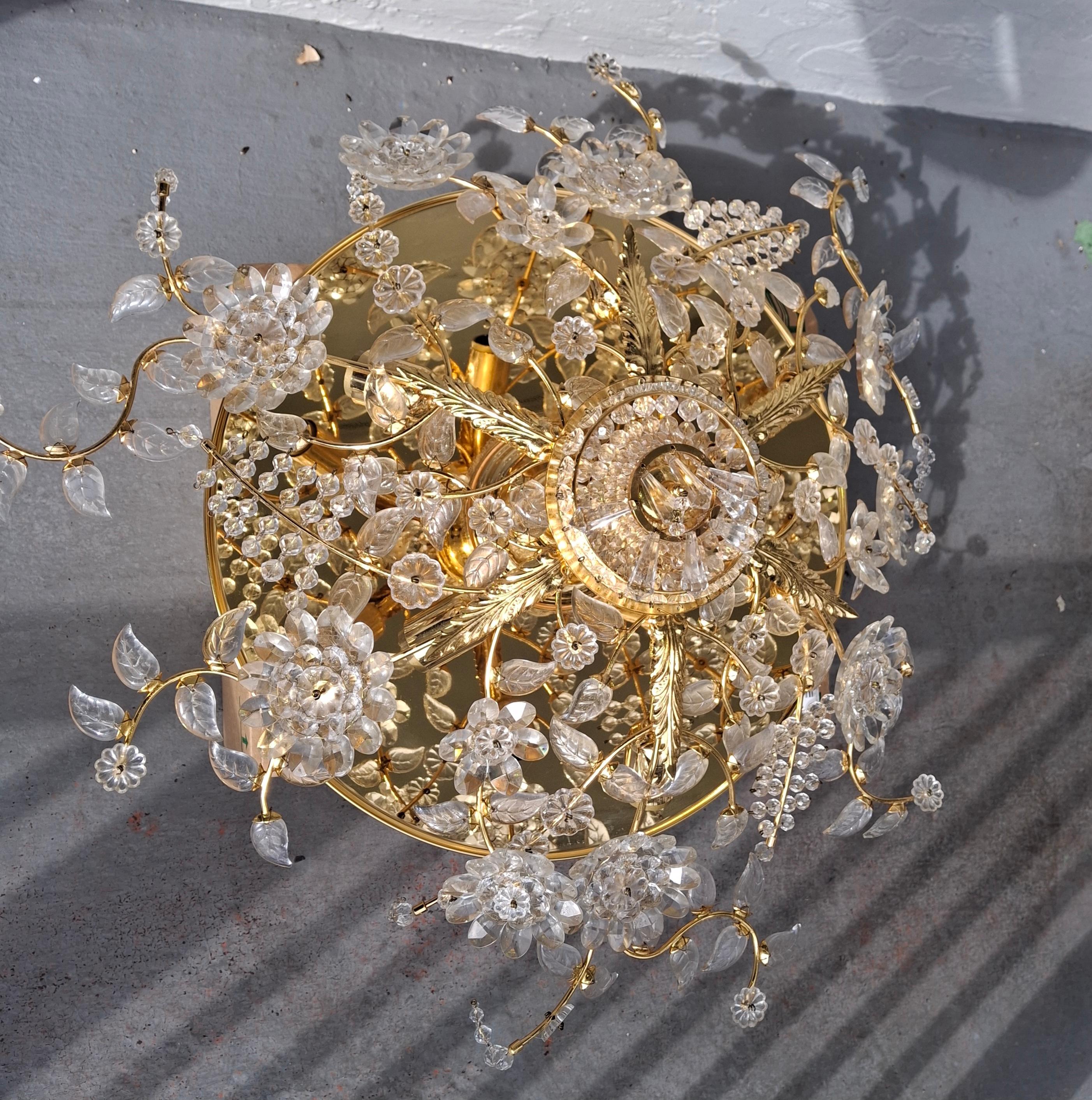 Grand Scale 1970's Hollywood Regency style 24K Gold Plate with Cut Crystal Floral Form Flush Mount Ceiling Fixture/ Chandelier. 6 light and very high quality, manufactured by Palwa. 6 interior lights. The frame is gold plate. All crystal present and