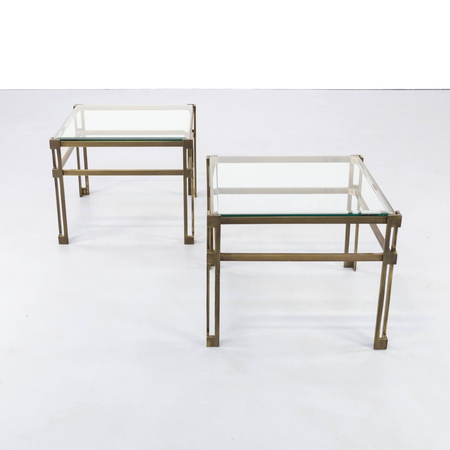 1970s Hollywood Regency style side table for Maison Jansen set of 2. Stylish pair of Regency brass and glass side tables. Brass frame with glass surfaces. Good condition consistent with age and use.