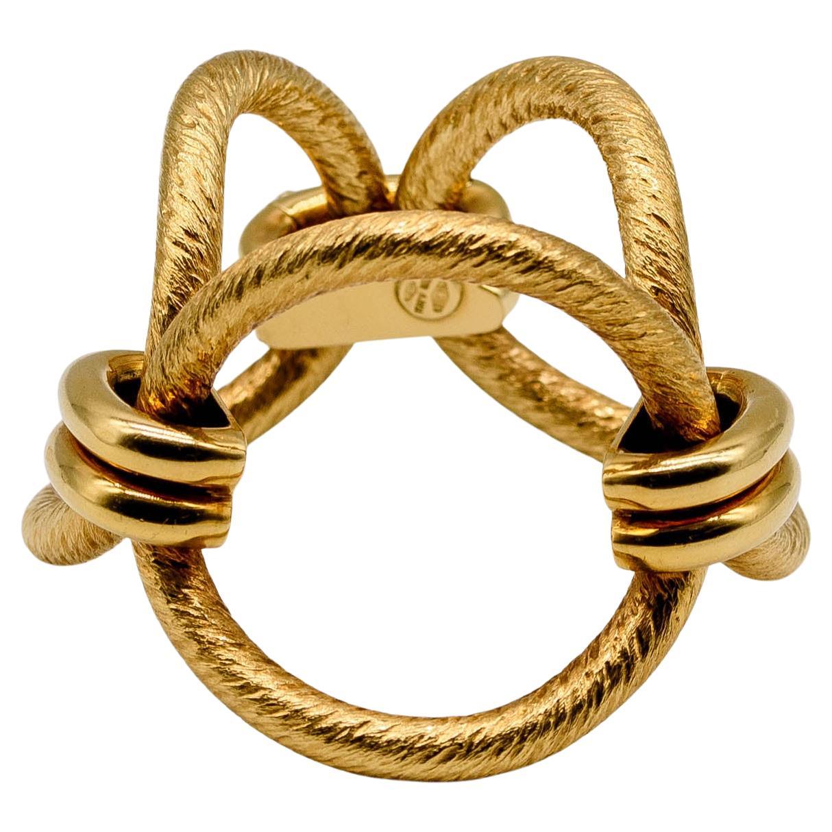 We don’t use the term “statement” lightly here;  when worn, this extraordinary jewel will rapidly become a focal point in any room.  Three large concave circles of twisted 18 karat gold are linked together by dual domes of highly polished gold. 
