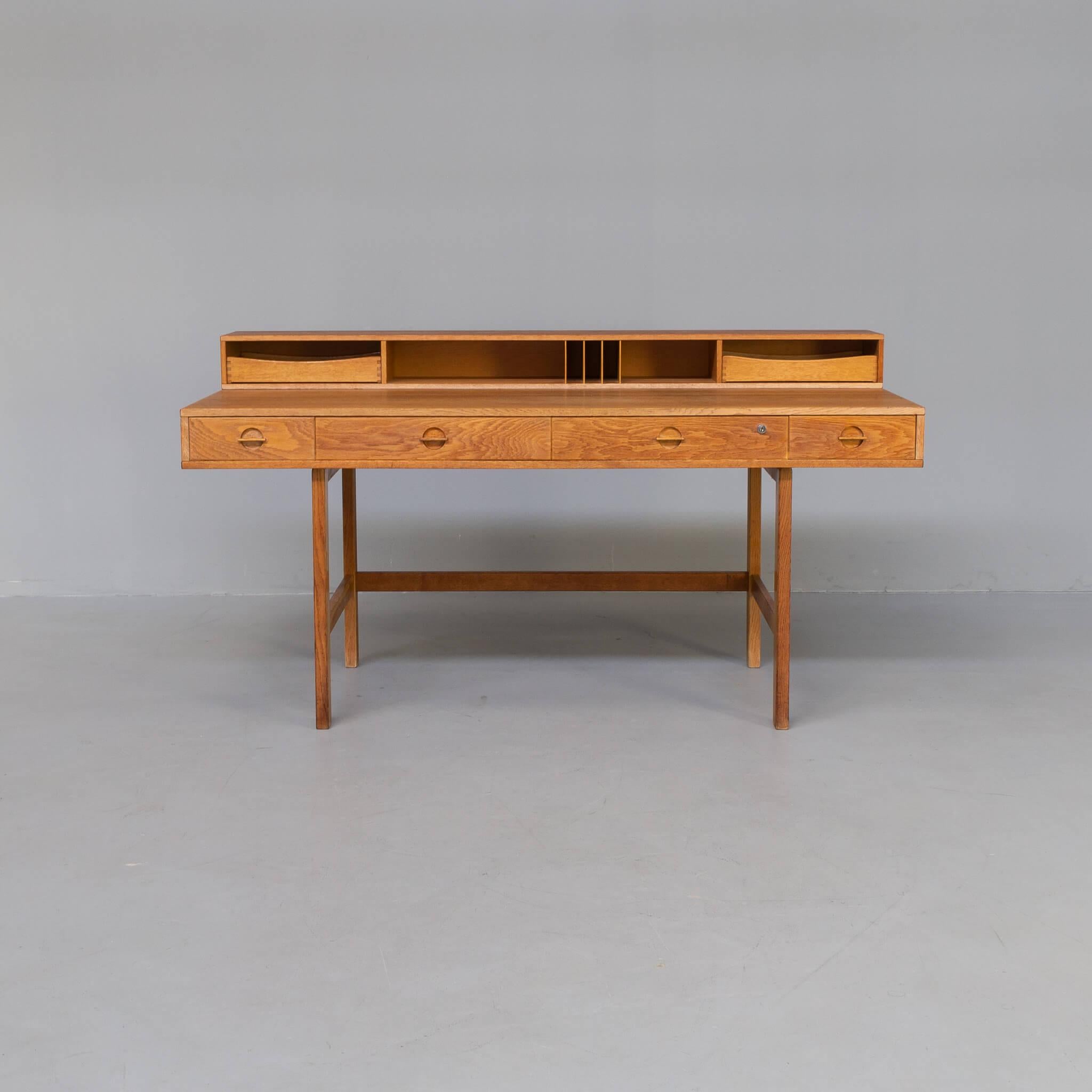 Jens Quistgaard designed the free-standing writing desk for Peter Løvig Nielsen in Denmark in the 1960s. It features a unique flip-top (foldable desk top unit) for added work space. There are several drawers and compartments. Jens Harald Quistgaard