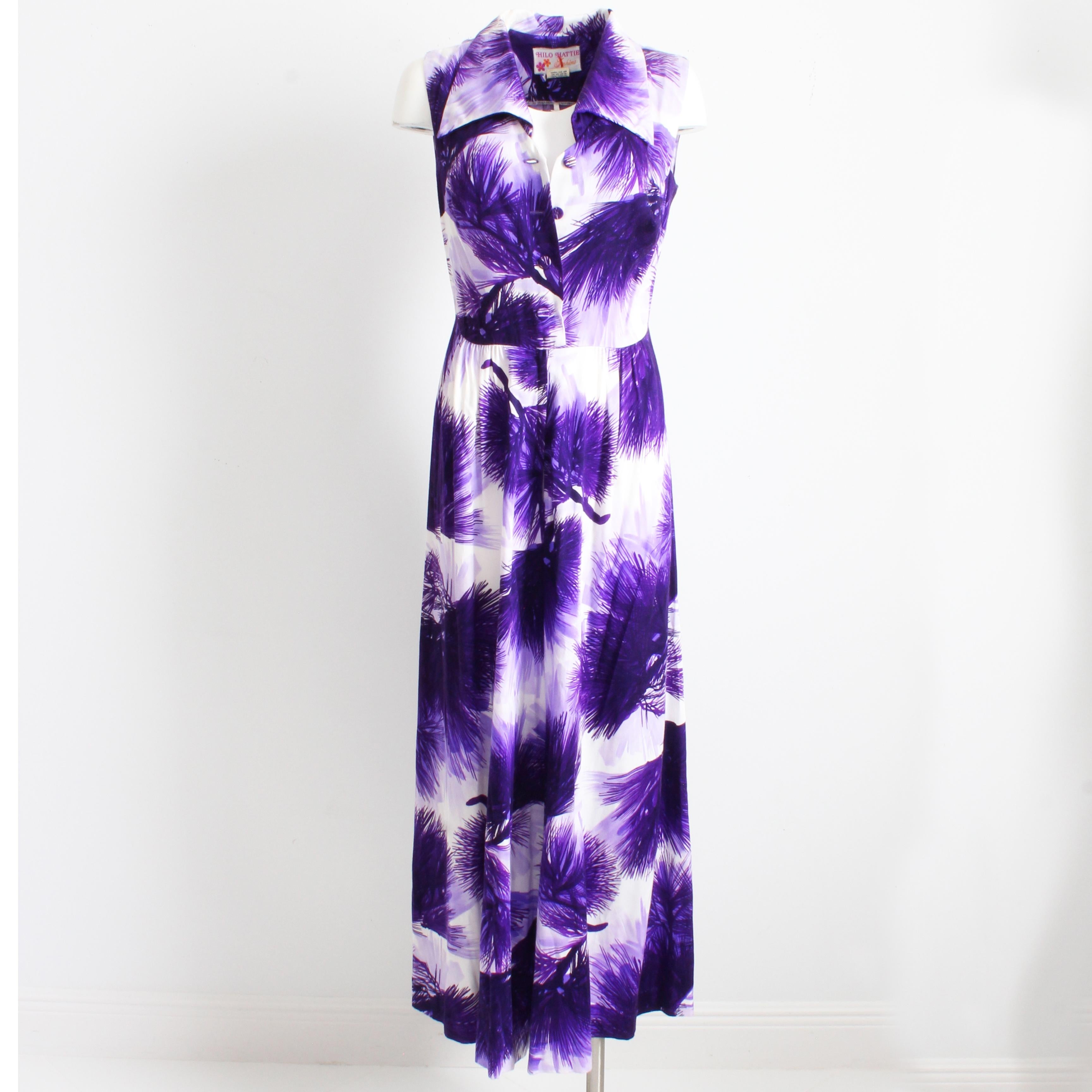 A fabulous vintage palazzo jumpsuit, made by Hilo Hattie in the 1970s.  Made from a poly-blend fabric, it features a vivid lavender and lilac hued floral print against a white background.  The palazzo pant legs are both comfortable and stylish, and