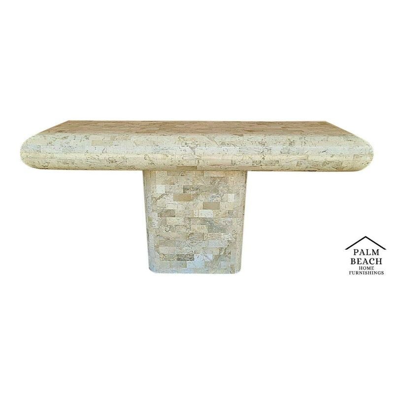 Offering one of our recent Palm Beach Estate Fine Furniture Acquisitions of A 1970's Karl Springer Maitland Smith Style Tessellated Fossil Stone Pedestal Console Table with Radiused Edges and Recessed Pedestal Base In the Maitland Smith, Karl