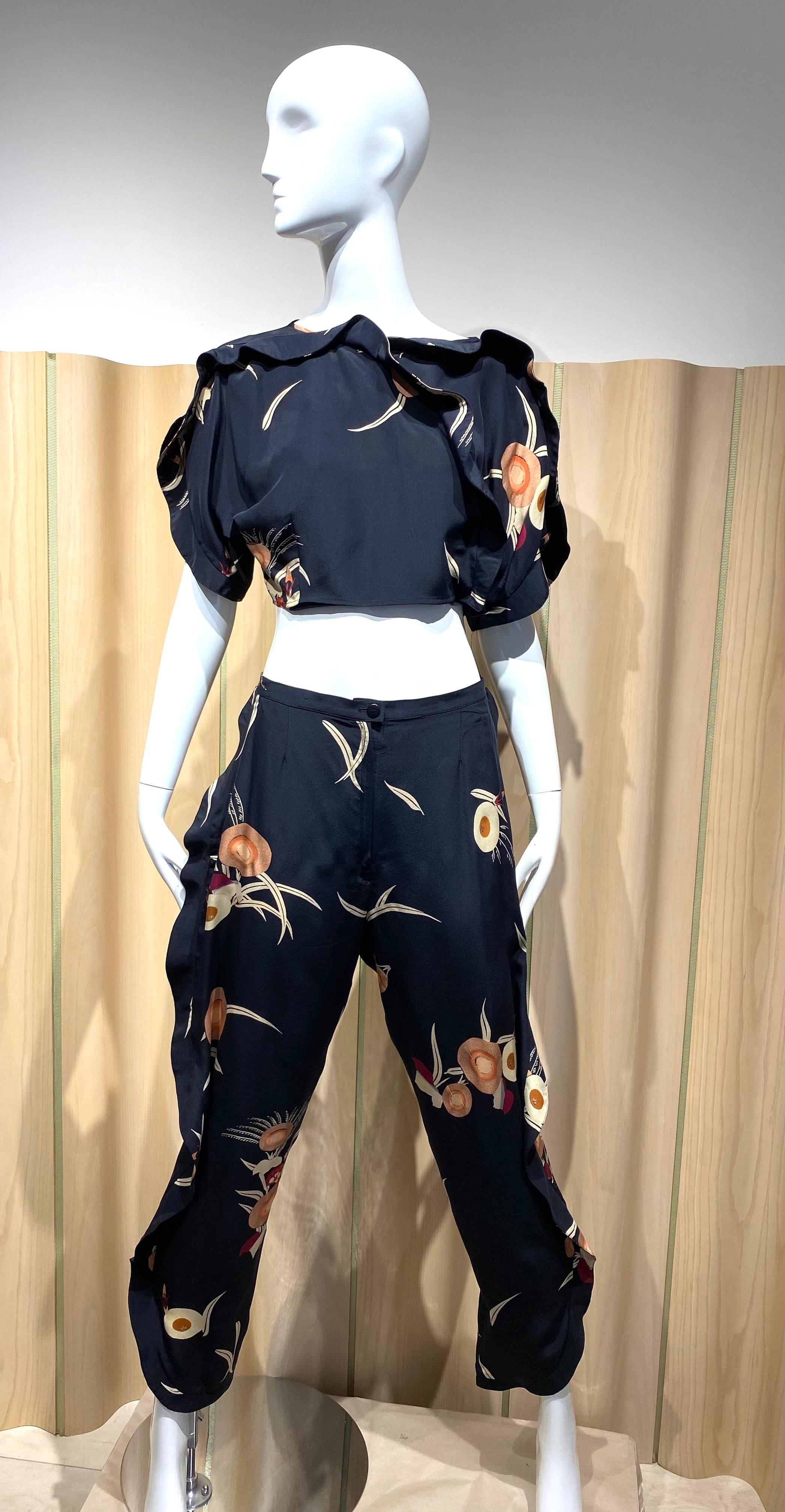 Vintage Krizia Black silk floral print ruffle crop top and pant set.
Krizia Top measurement 
Bust: 36”/ 
Pant Waist 28” / Hip : 40”. / Pant length : 39” / inseam 27 1/2
