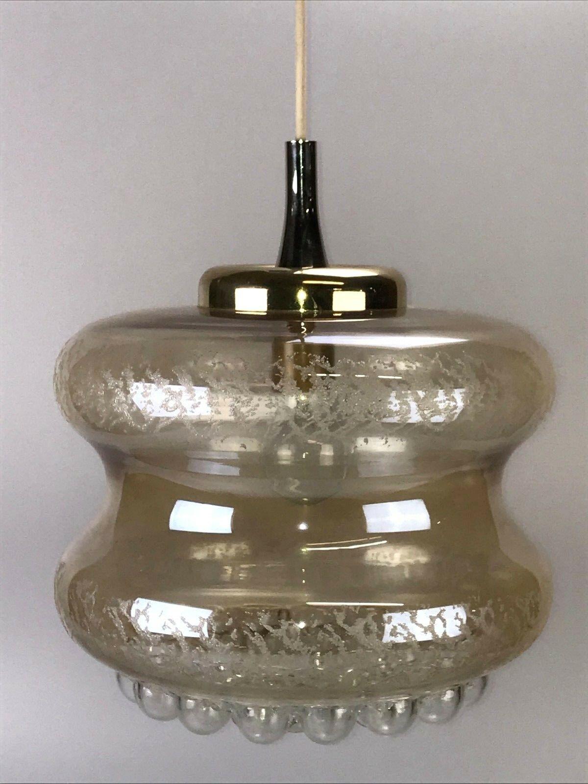 70s Lamp hanging lamp ball lamp bubble brass glass space age design.

Object: ceiling lamp

Manufacturer:

Condition: good

Age: around 1960-1970

Dimensions:

Diameter = 31cm
Hanging height = 85cm

Other notes:

The pictures serve