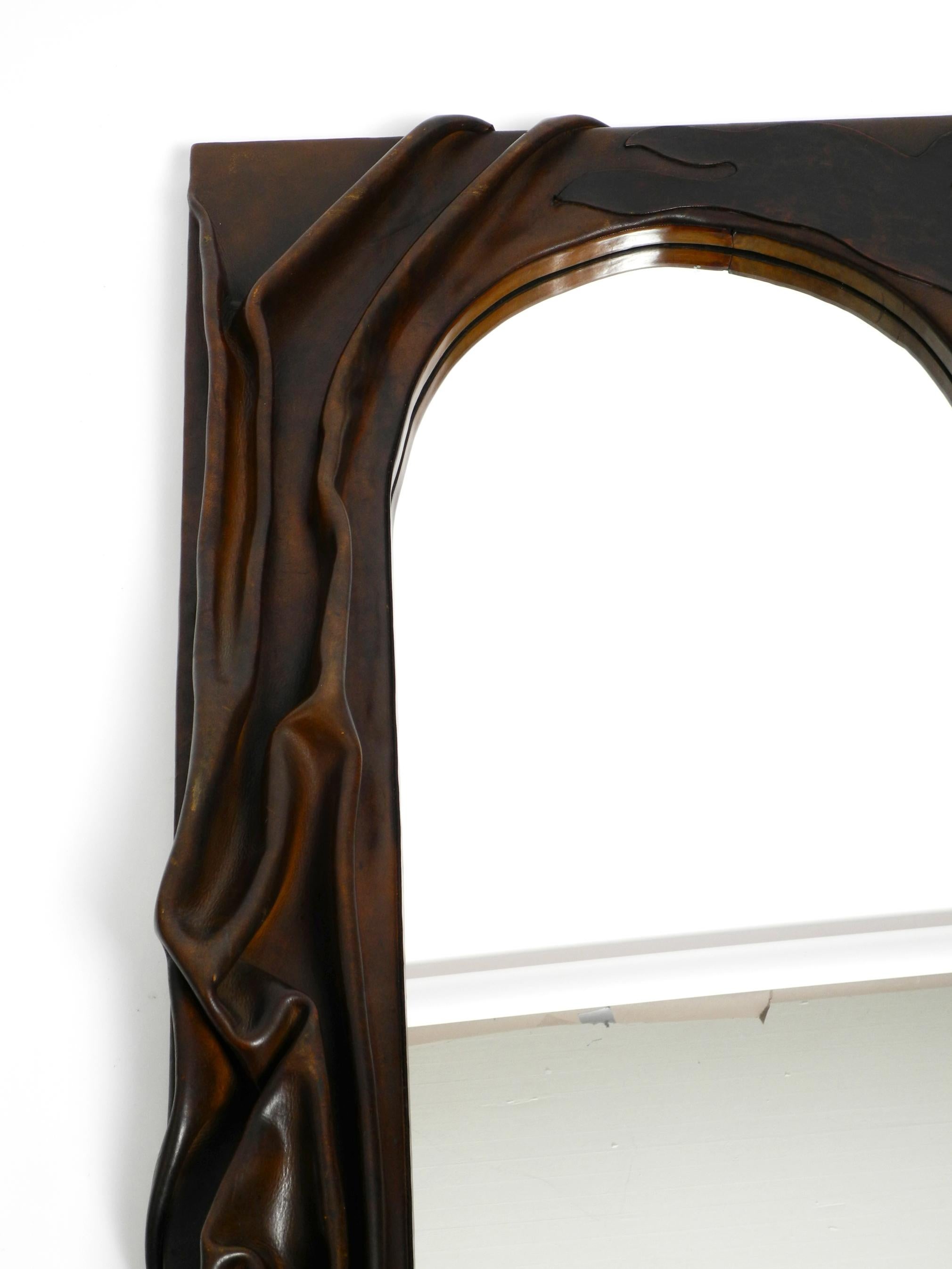 70s large wooden wall mirror with an elaborate and thick flowing leather cover  For Sale 5