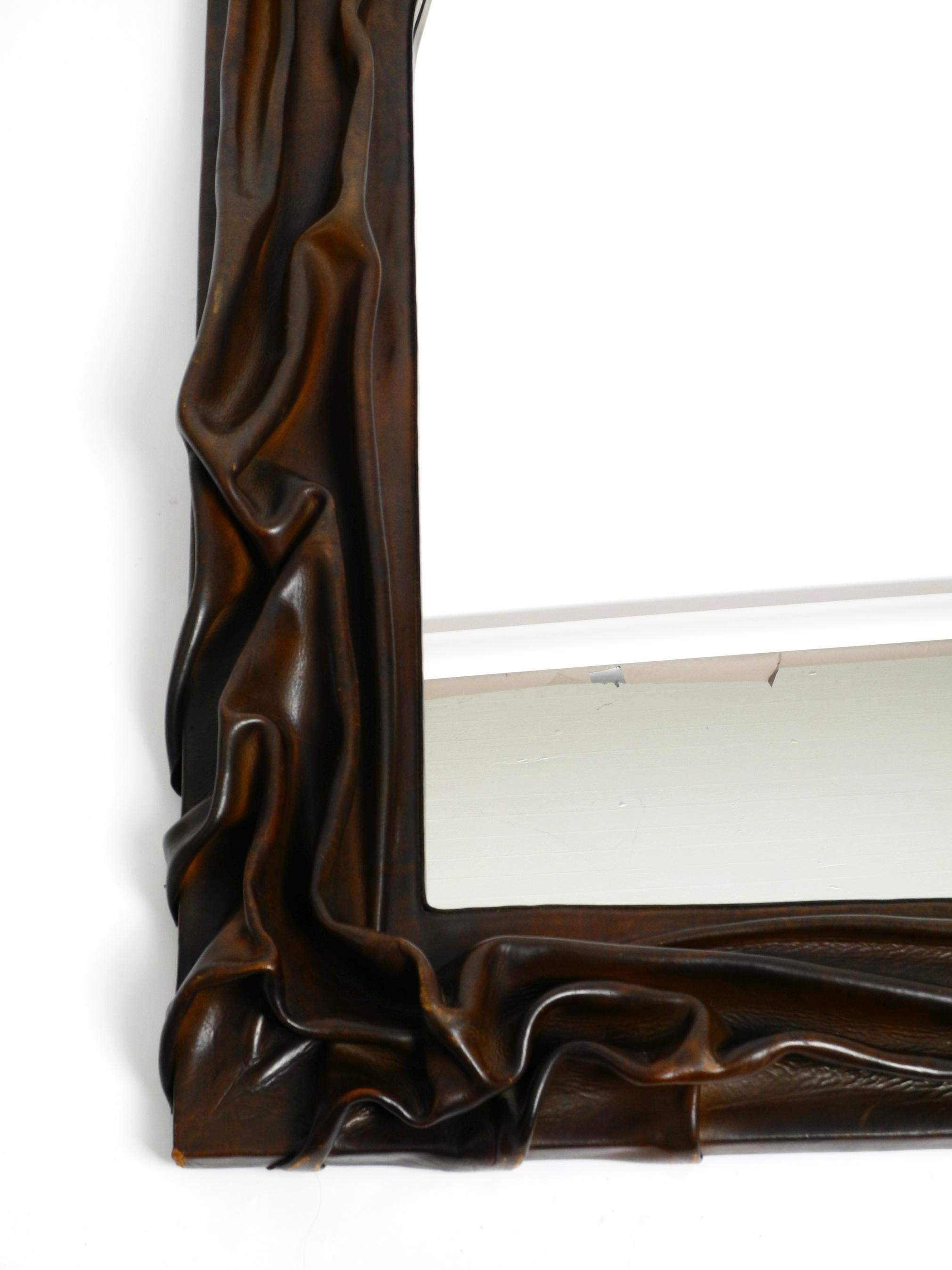 70s large wooden wall mirror with an elaborate and thick flowing leather cover  For Sale 9
