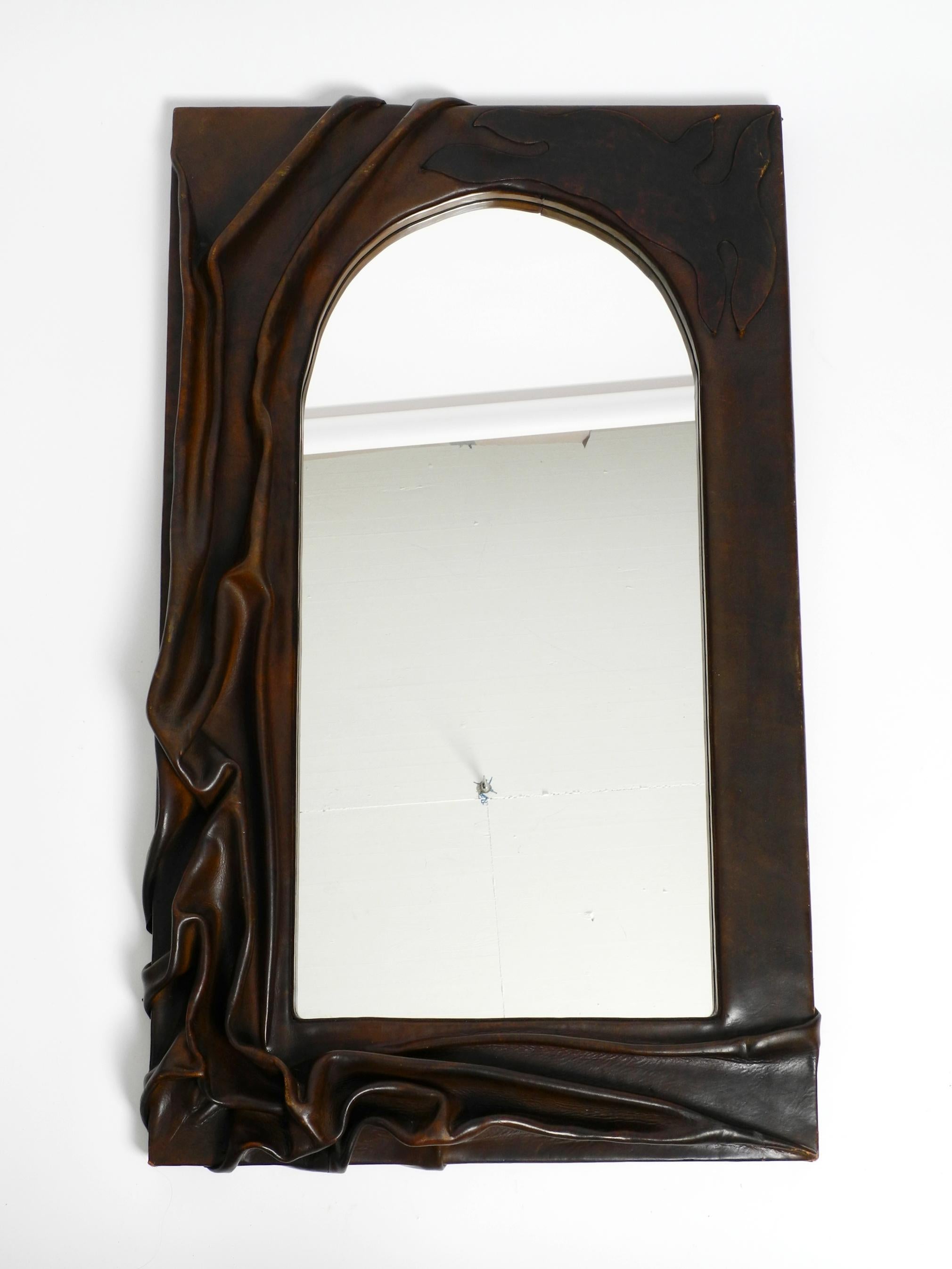 70s large wooden wall mirror with an elaborate and thick flowing leather cover  For Sale 10