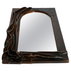 70s large wooden wall mirror with an elaborate and thick flowing leather cover