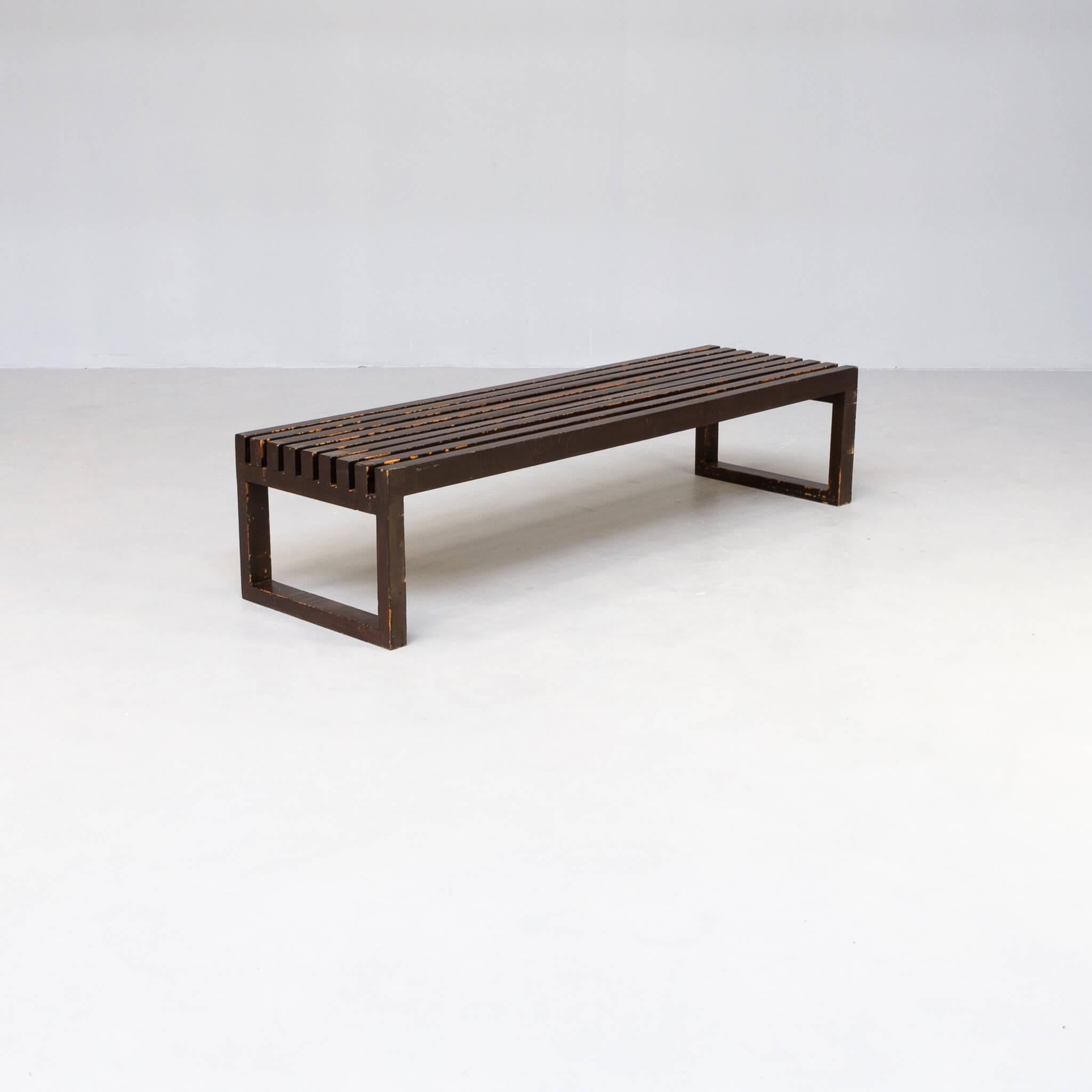 This slatted bench has a beautiful design. The bench is fit for 3 persons and is painted in dark brown paint in the 1990s. We think the wood is in teak or oak, it is firm stable and in good condition.