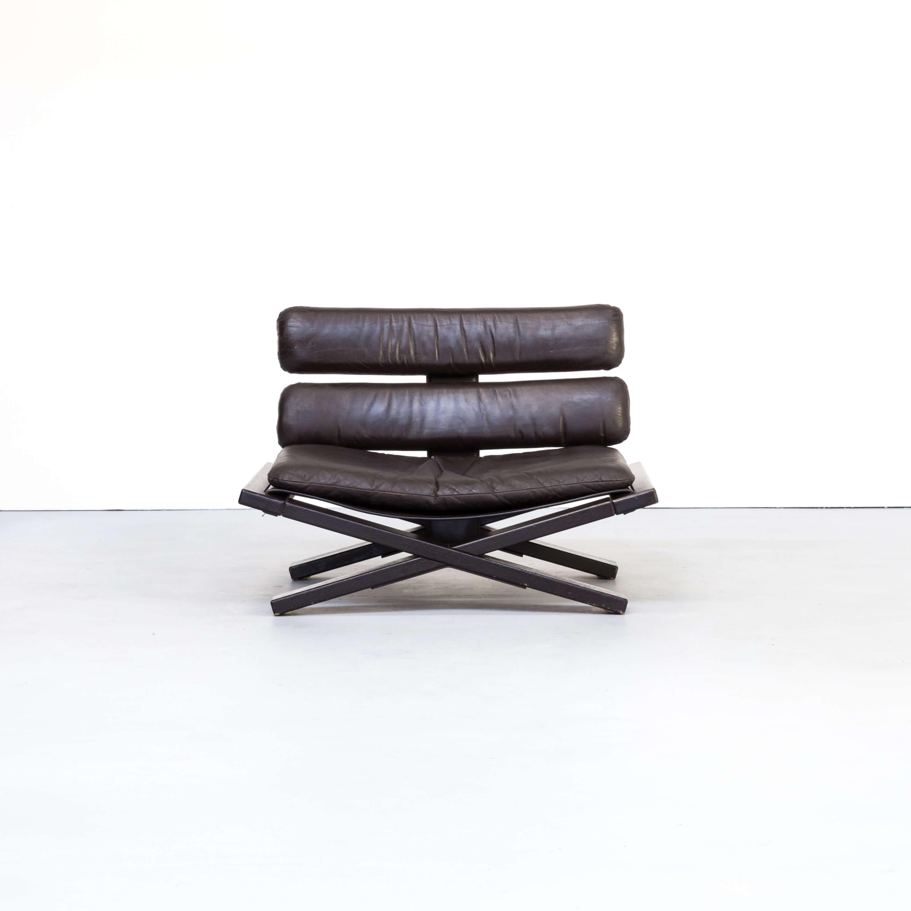 1970s lounge chair ‘Buddha’ designed by Sonja Wasseur. This Buddha chair is designed in the early 1970s and made of solid oak wood, dark brown stained. The seat and back are finished with leather, superbly stitched at the back with a metal structure