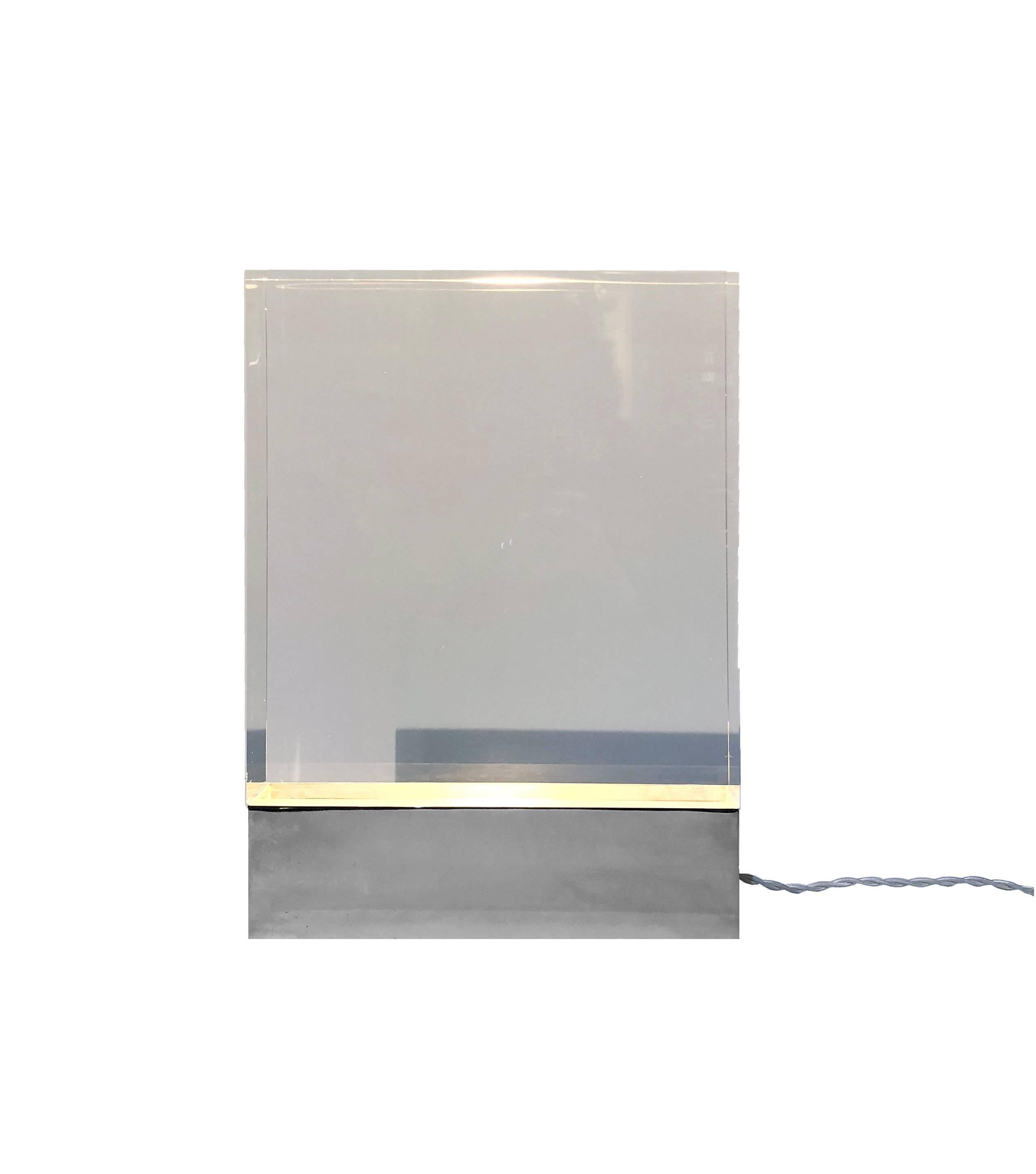 Awesome table lamp in Lucite, it is made of a full block of extra clear plexiglass and a nickel plated brass base, where is located the electric parts.
Methacrylate also known as plexiglass is a material with several characteristics: it is clearest