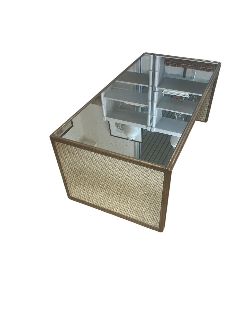 70's Mirrored Waterfall Coffee Table. Mirror is antique finished with gilt trim with aged patina