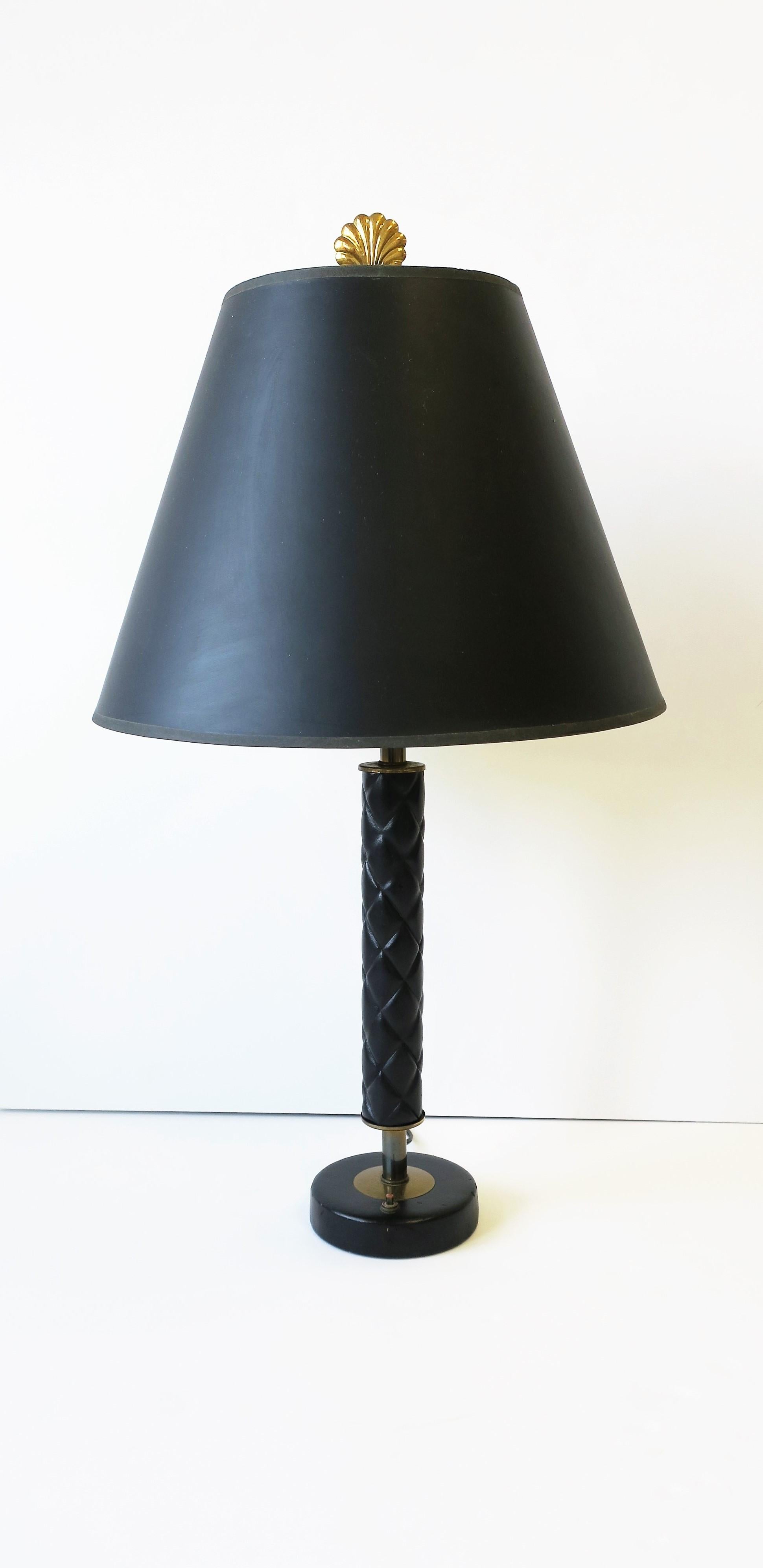 A very beautiful and chic '70s modern black quilted leather and brass desk or table lamp, circa 1970s or a little earlier.
On/Off switch in two areas; on base and at top/socket. 

Measures: 
5