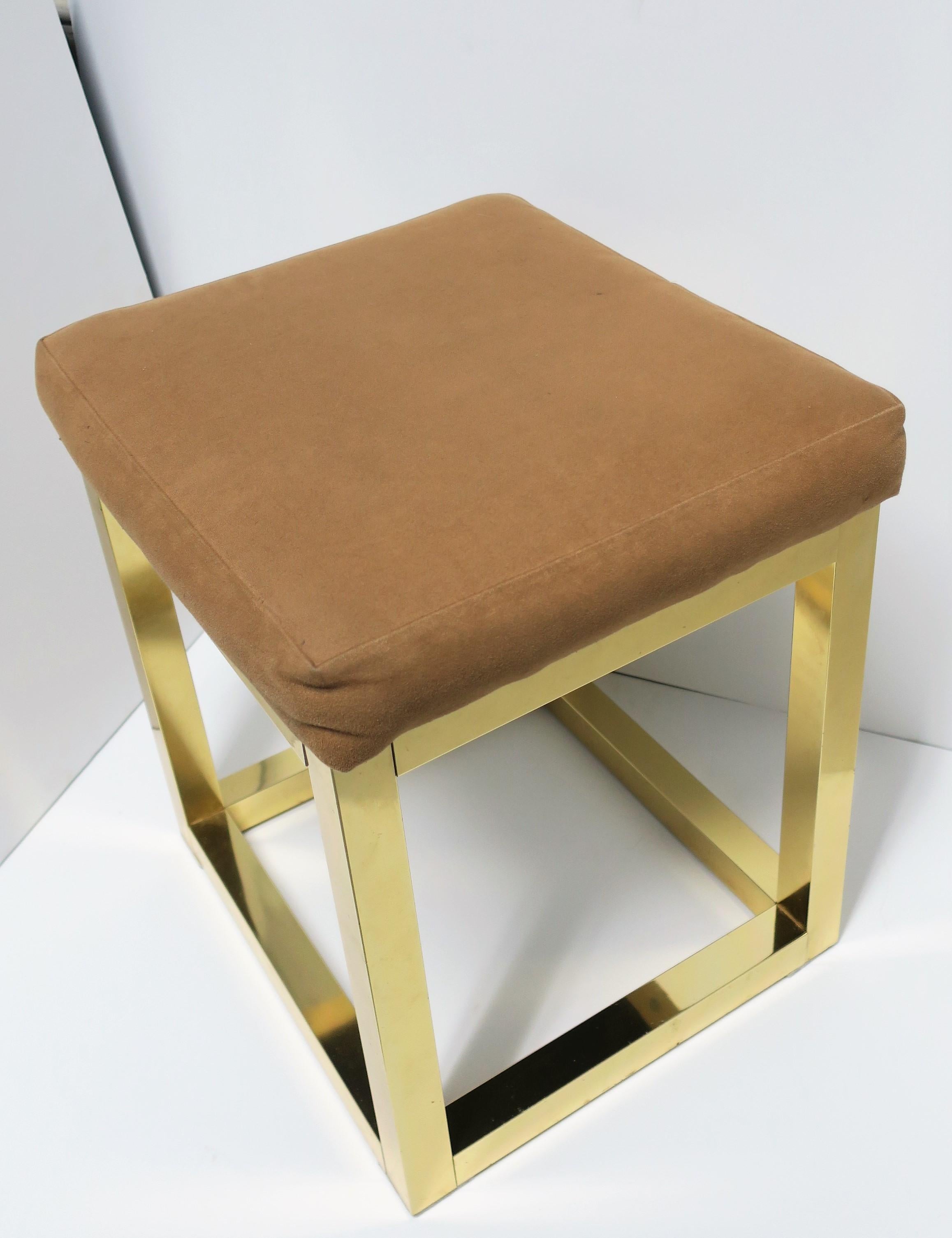 A 1970s modern brass bench or stool with upholstered seat cushion in the style of designer Paul Evans, circa 1970s.

Measurements: 13.75