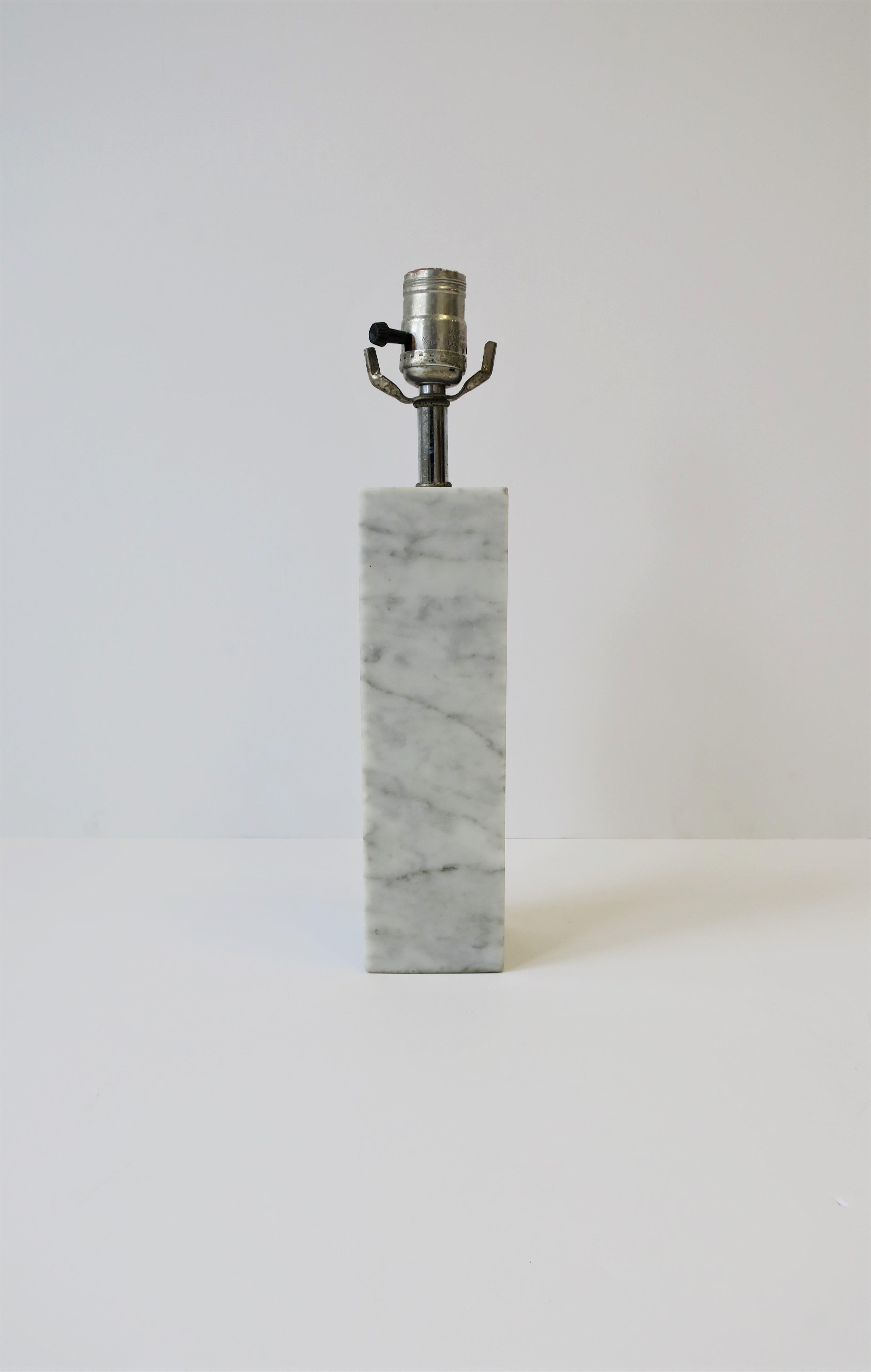 An Italian Modern Postmodern period Carrara marble (white, grey and black) table or desk lamp, circa 1970s, Italy. Light would work well on a desk, vanity, small table, etc. Lamp is a convenient size, measurements below. Rewiring and new harp