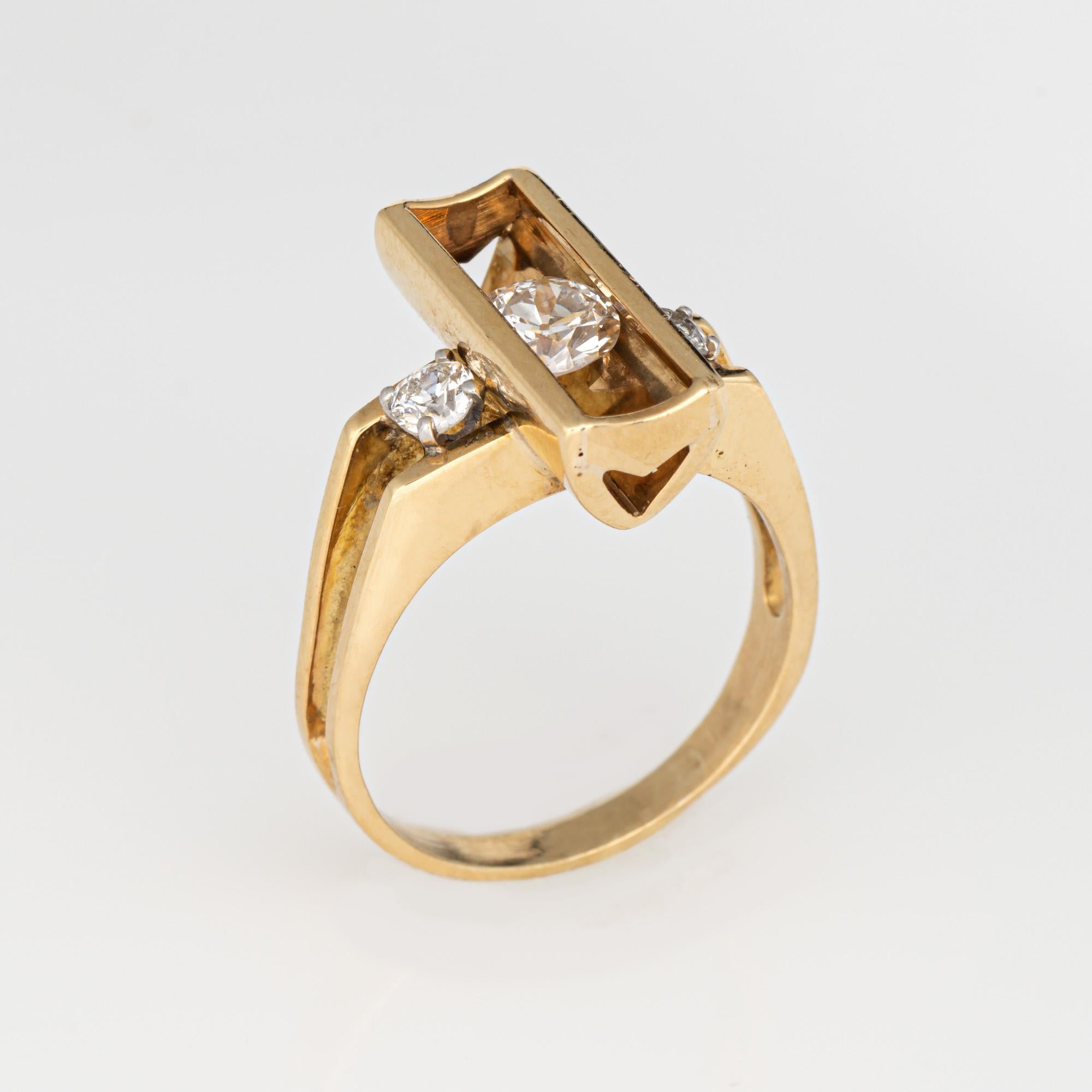 Fun & distinct vintage diamond ring (circa 1970s), crafted in 18 karat yellow gold. 

One estimated 0.40 carat old European cut diamond is set to the rectangular center with two smaller estimated 0.05 carat diamonds to the side shoulders. The total