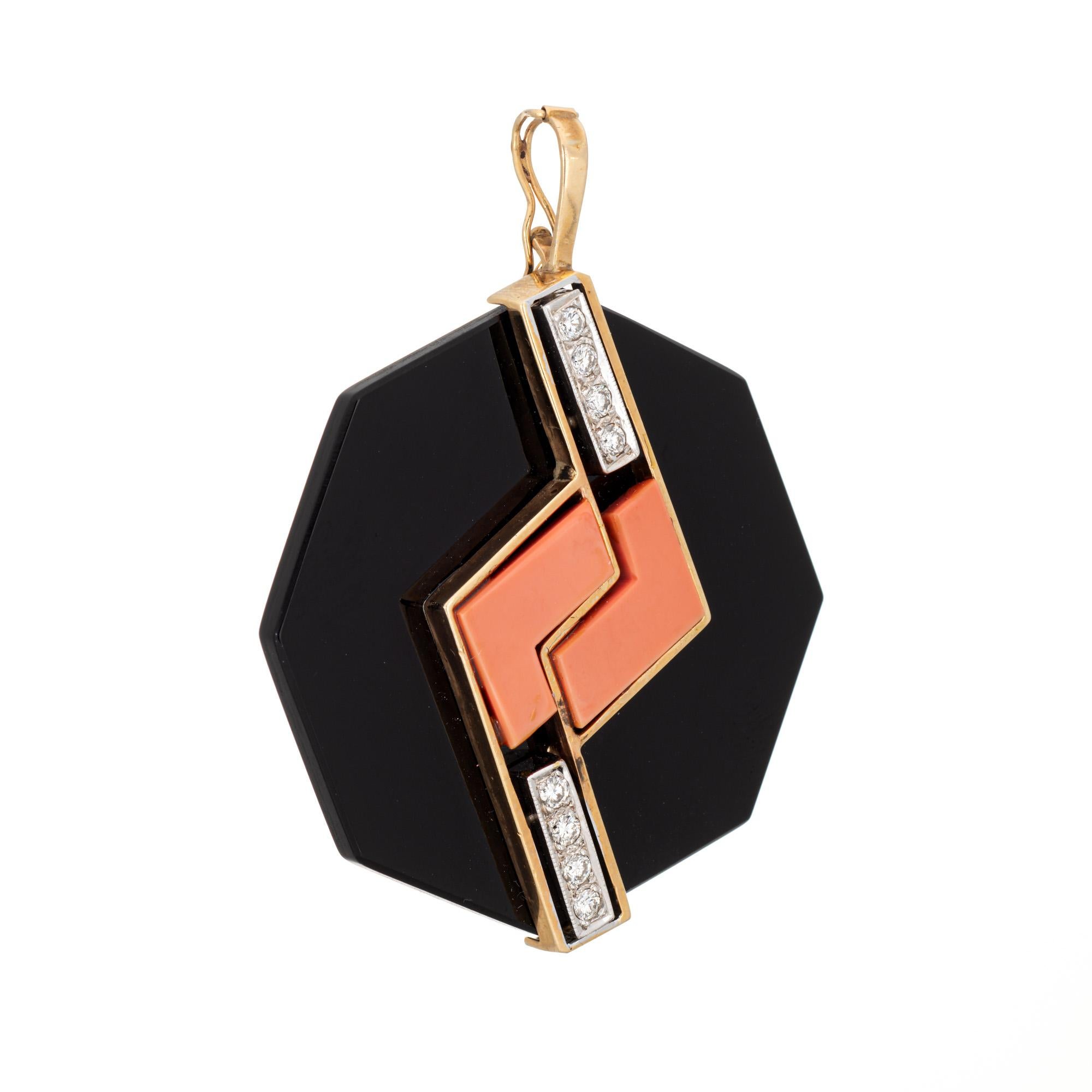 Finely detailed onyx, coral and diamond pendant crafted in 14 karat yellow gold (circa 1970s). 

Onyx measures 1.75 inches. Coral measures 14mm x 5mm. Eight diamonds total an estimated 0.16 carats (estimated at H-I color and VS2-SI2 clarity). The