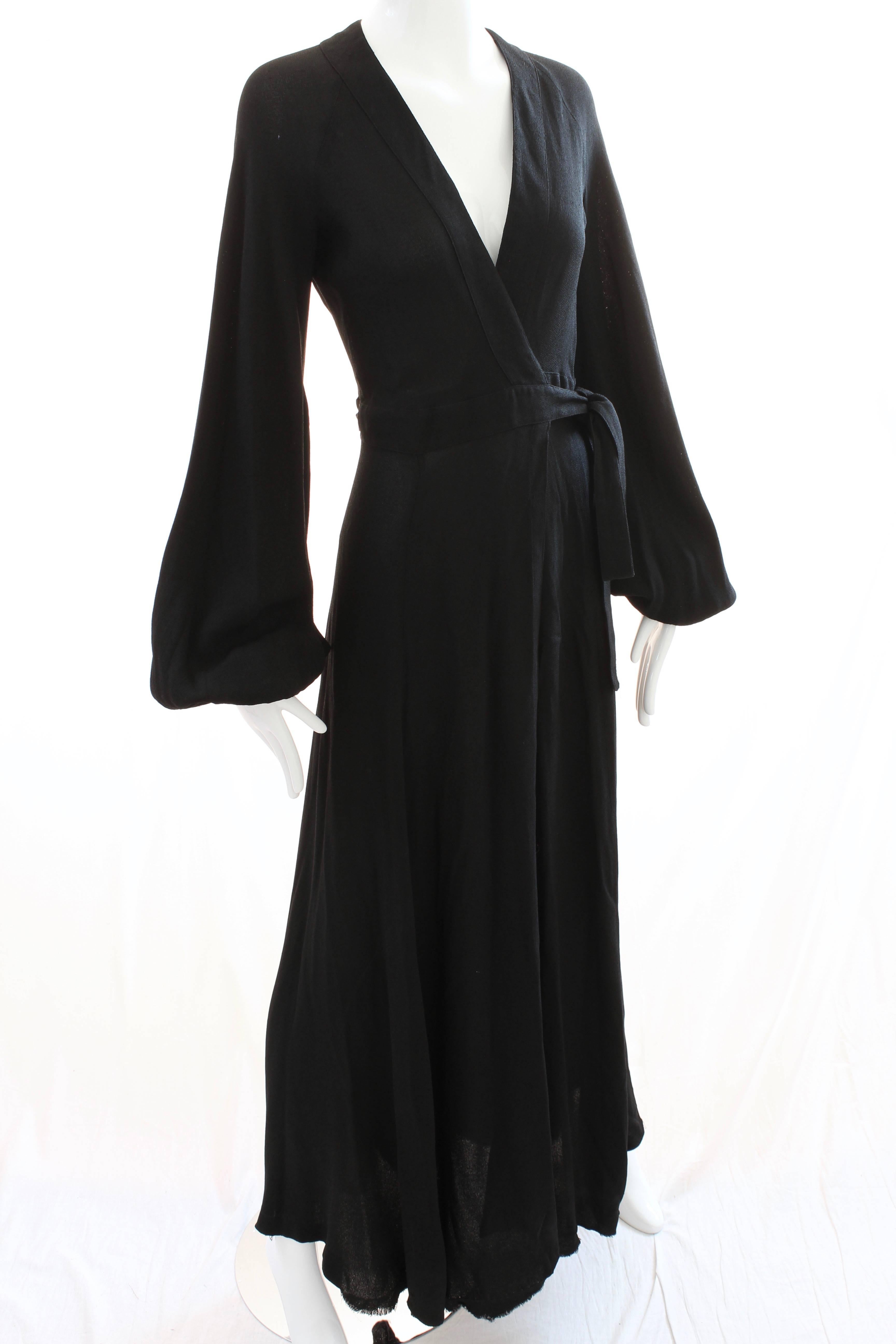 Here's a fabulous long dress by British designer Ossie Clark for Quorum. Dating to the early 1970s, it's made from Ossie's signature black moss crepe, features wrap ties, a low cut chest and a sexy cut out in back. In good vintage condition, the