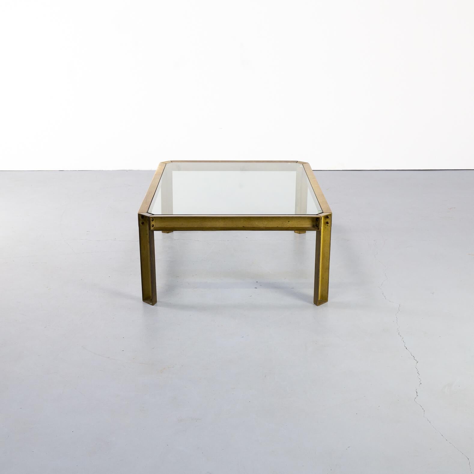 In the 1970s Peter Ghyczy designed iconic glass tables in brass frames. This model 'T09 emabssy' coffee table is a kind of opposite of the other and 'slim' Ghyczy designs. The thick solid brass frame is very visible and is being softened in its