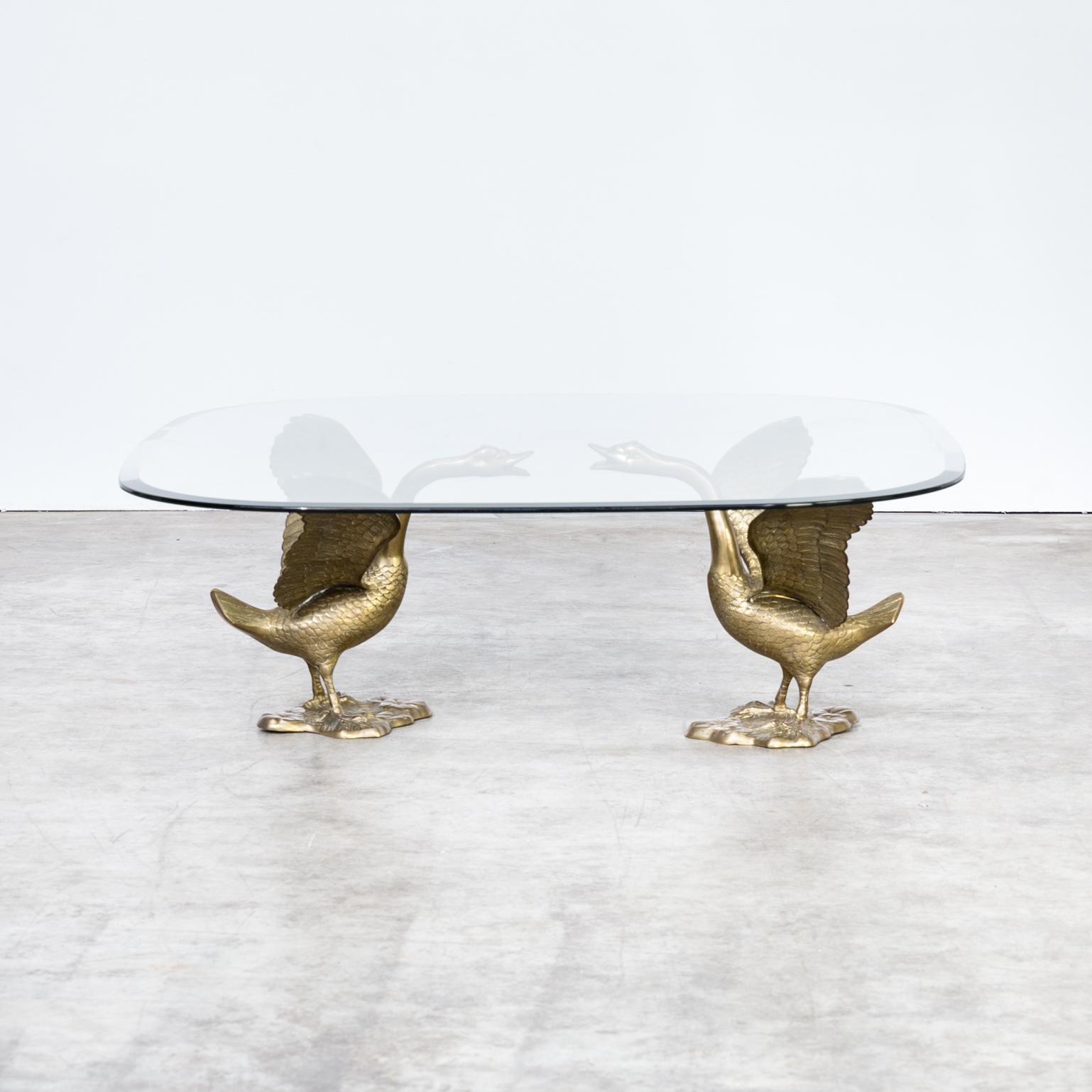 1970s sculptural ‘goose’ coffee table with glass table top. Beautiful brass goose who carry the glass table top coffee table on their wings. Sculptural design in good condition consistent with age and use.