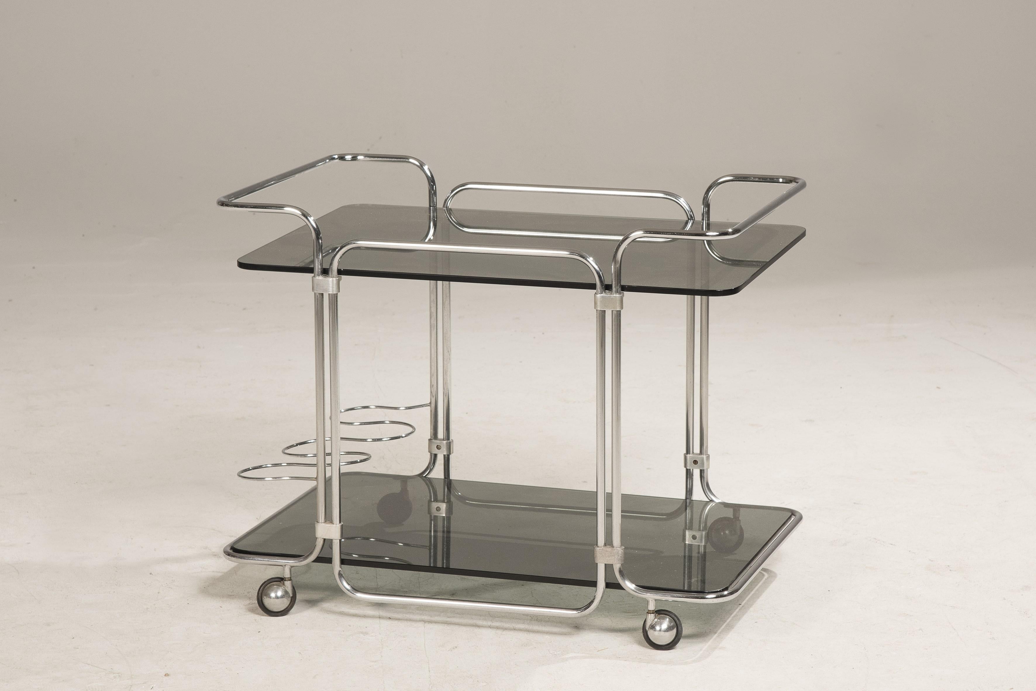 1970s steel wheeled two smoked glass shelves cart with steel bottles holder.
No restoration needed.