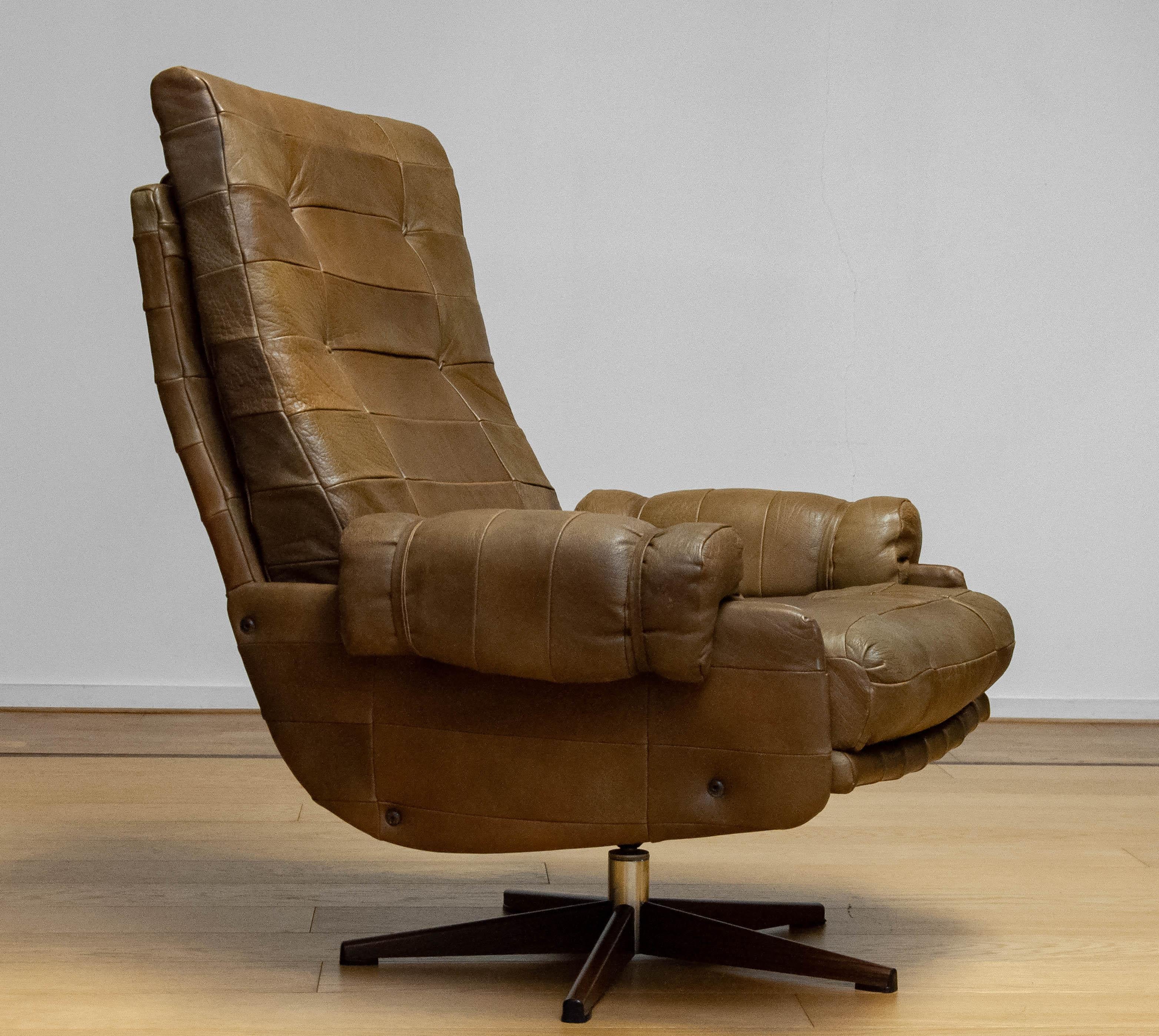Swedish 70s Swivel Chair By Arne Norell Möbel AB In Sturdy Olive Green Patchwork Leather For Sale