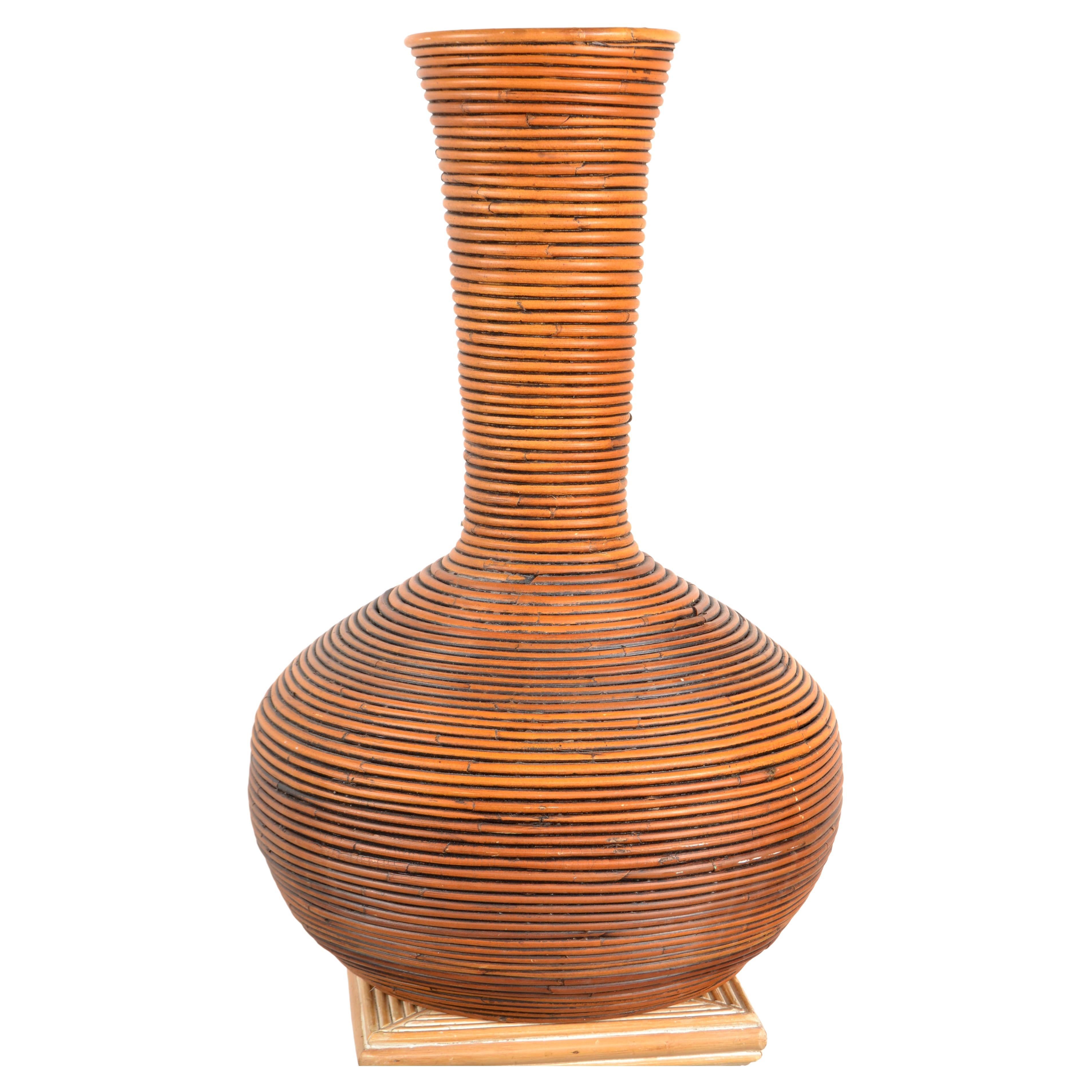 Handcrafted tall boho chic brown pencil reed, cane and bamboo floor vase in cone shape.
Great Mid-Century Modern addition for Your Sunroom.
Measurements:
Top Diameter: 7 inches.
Core Diameter: 14.5 inches.
Height: 24.38 inches.
