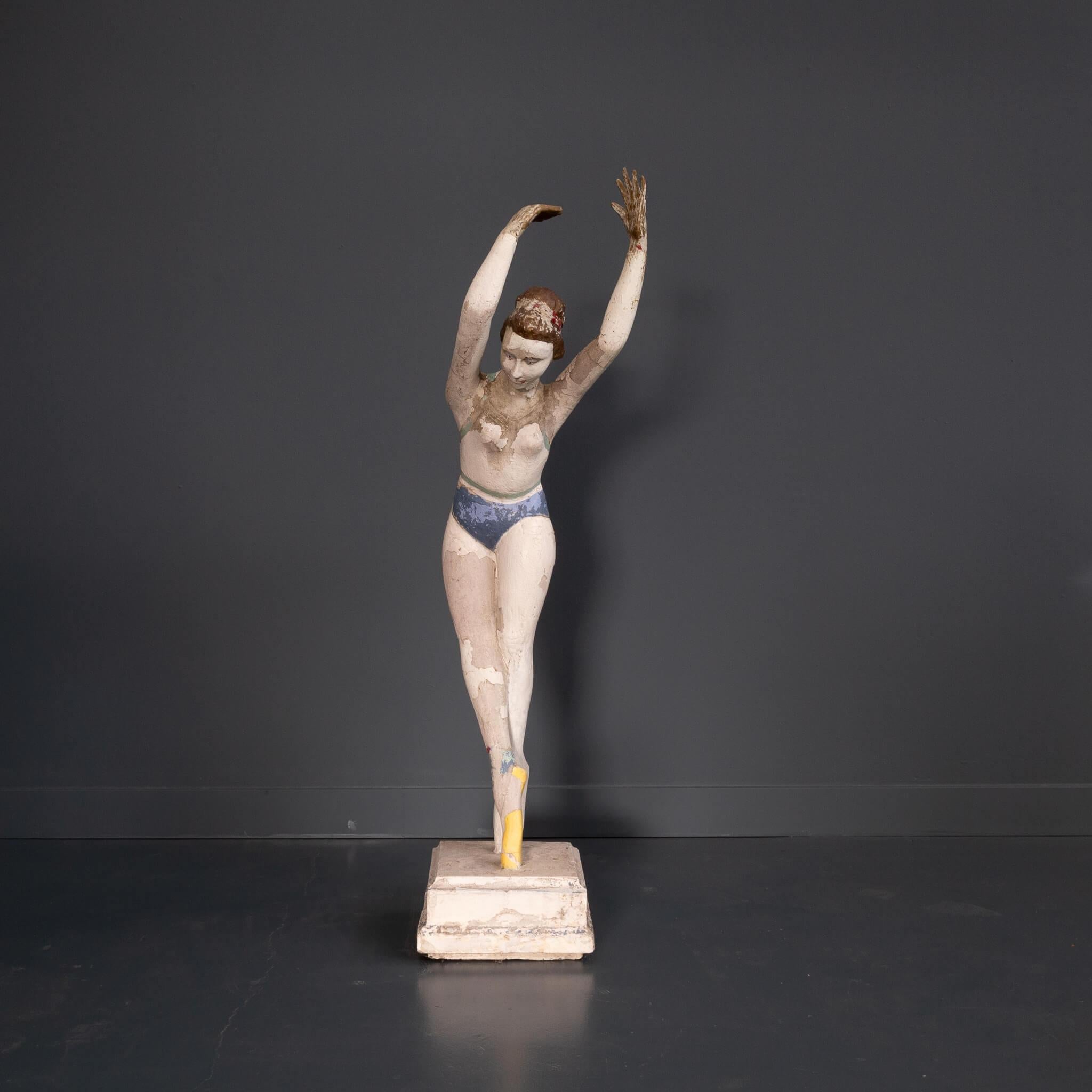 Beautiful statue made of concrete, cement. This image evokes an enormous contradiction. The dance of a ballerina is always very smooth due to the flexibility of the athletic ballerina. The contrast is in the material used, concrete rigid and hard,