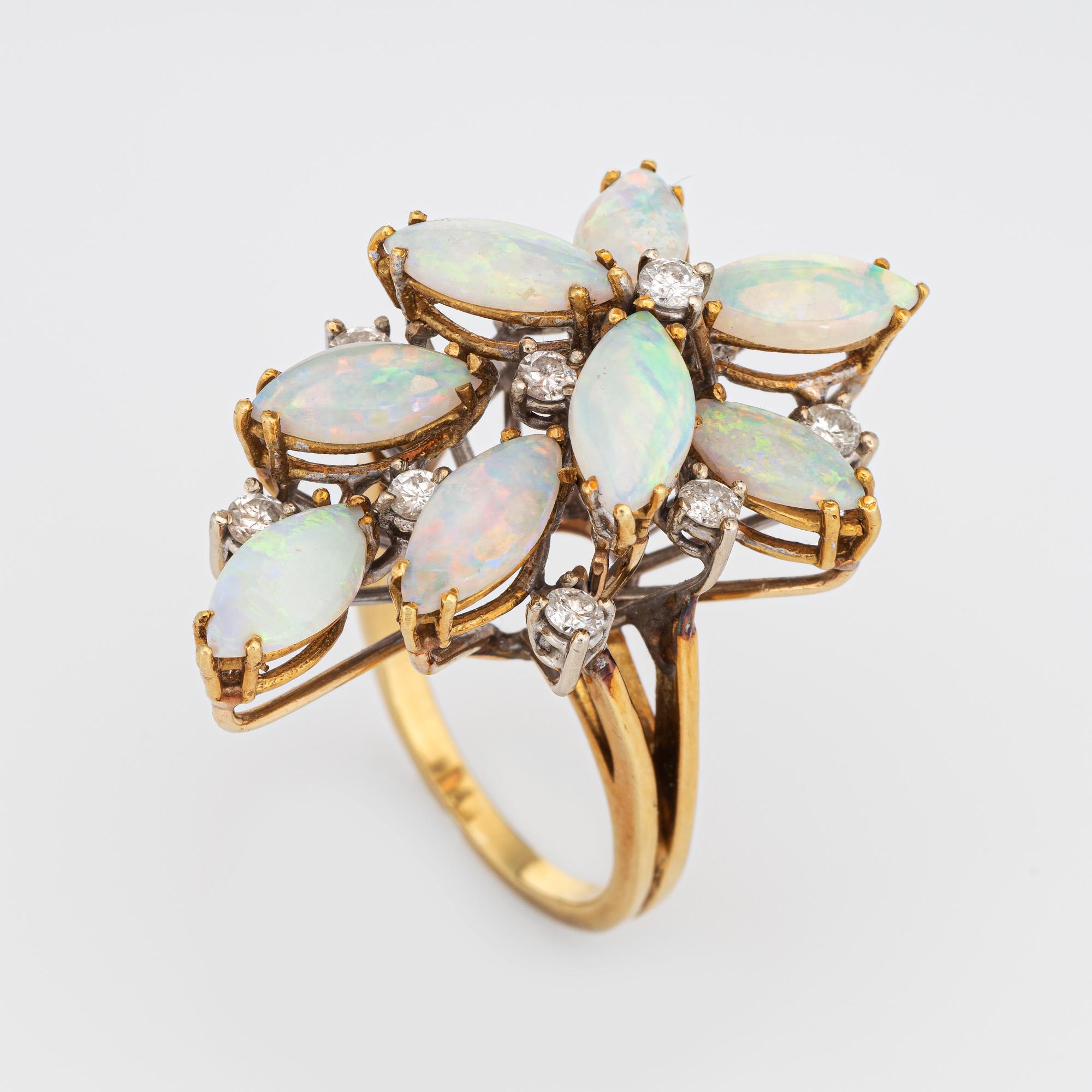 Stylish vintage opal & diamond cluster ring (circa 1970s) crafted in 14 karat yellow gold. 

Natural opals measure 10mm x 4mm (estimated at 0.50 carats each - 4 carats total estimated weight). 11 round brilliant cut diamonds are estimated at 0.05