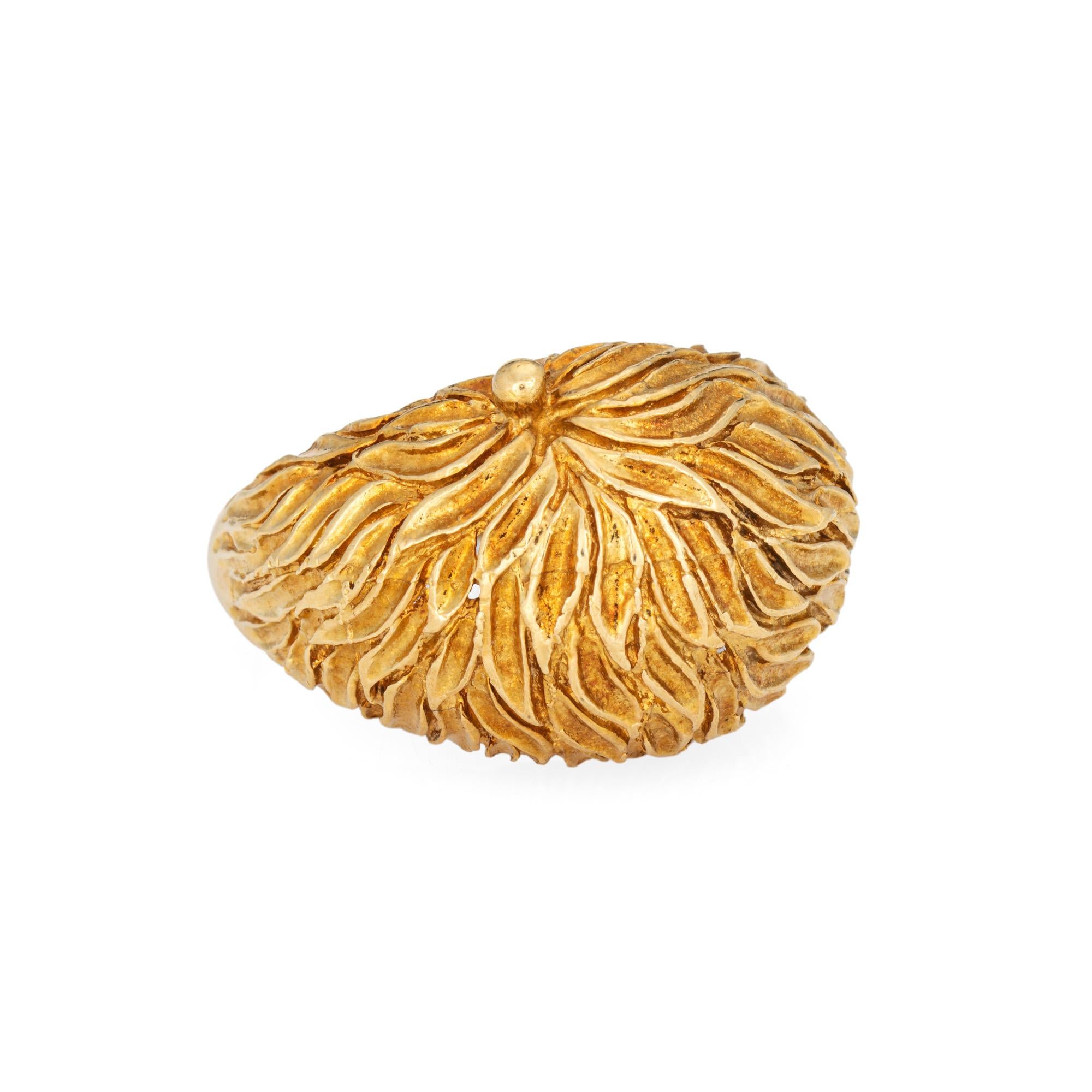 Stylish vintage textured dome ring (circa 1970s) crafted in 18k yellow gold. 

A textured foliate design adorns the domed mount. The medium-rise ring (8mm - 0.31 inches) sits comfortably on the finger and makes a great statement!

The ring is in
