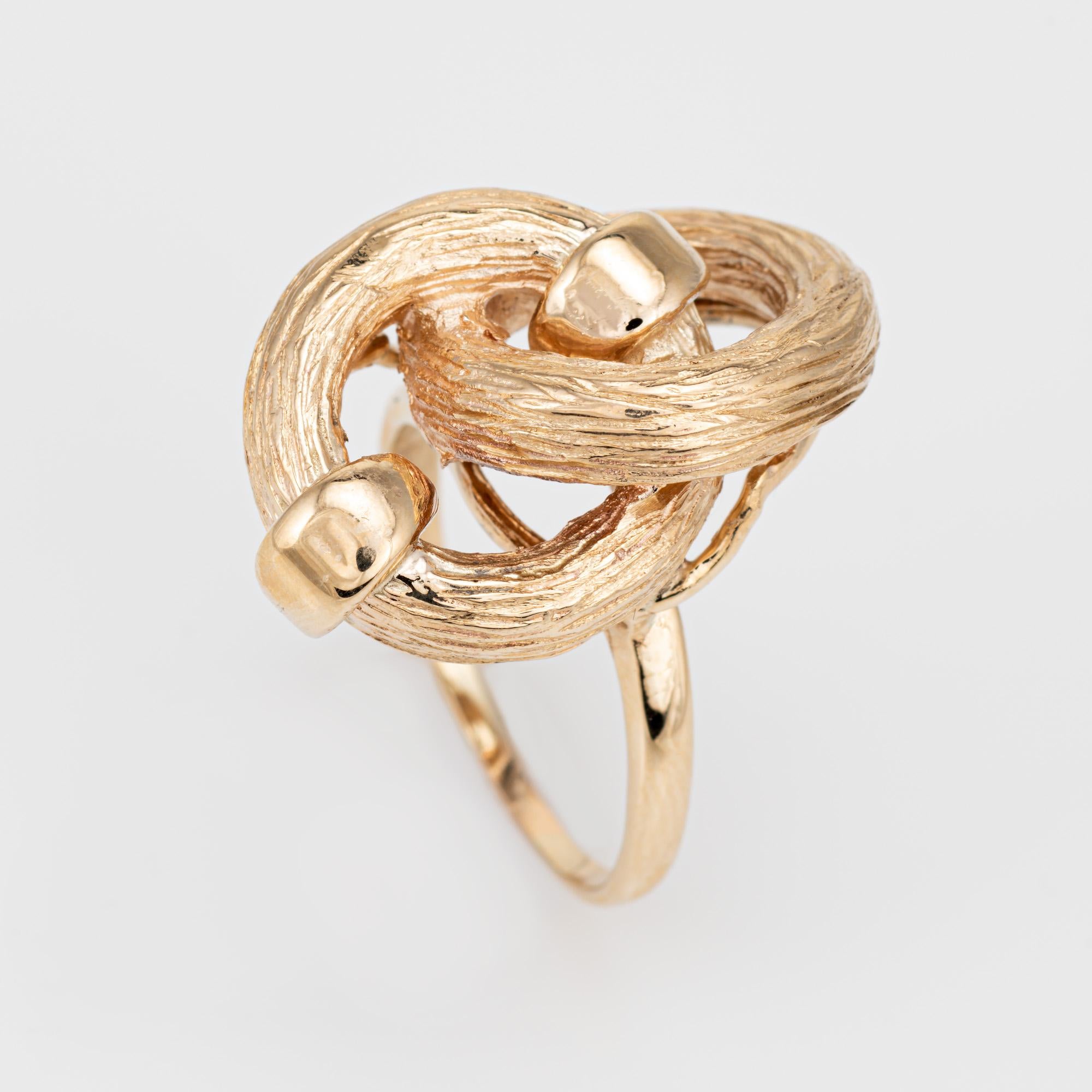 Stylish vintage infinity knot ring crafted in 14 karat yellow gold (circa 1970s). 

The infinity knot design is a meaningful symbol of interconnectedness and limitless possibilities. A timeless design that is a reminder of the enduring bond between