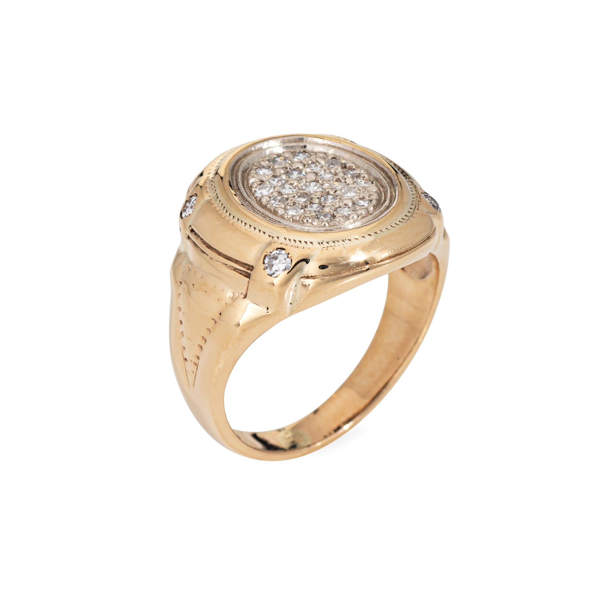 Stylish vintage oval signet ring crafted in 10 karat yellow gold (circa 1970s).

Single cut diamonds total an estimated 0.15 carats (estimated at I-J color and SI1-I1 clarity).  

The oval signet features pave set diamonds to the center. The ring is