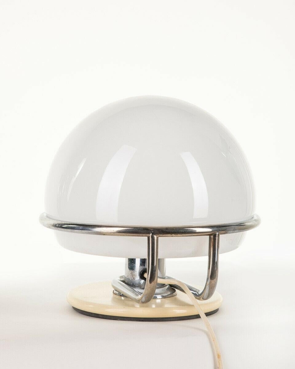 Table lamp in white and chromed metal with opal glass lampshade, 1970s.
CONDITIONS: In good condition, working, it may show signs of wear due to time.

DIMENSIONS: Height 25 cm; Diameter 25 cm

MATERIALS: Metal and Glass

YEAR OF PRODUCTION: