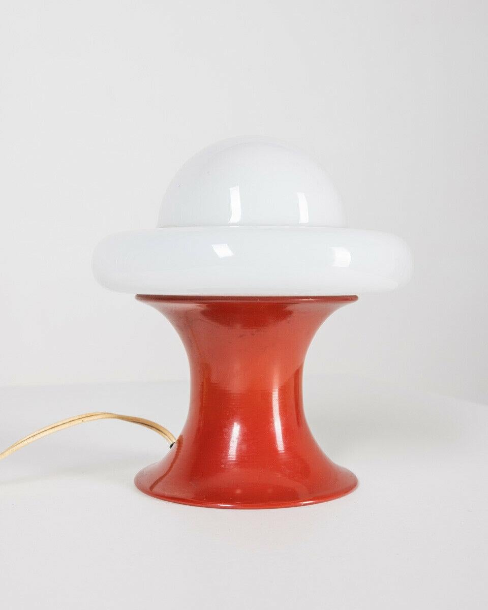 Table lamp with red metal base and glass lampshade, 1970s.

Conditions: In good condition, working, it may show slight signs of wear due to time.

Dimensions: Height 22 cm; Diameter 20 cm

Materials: Metal and Glass

Year of production: