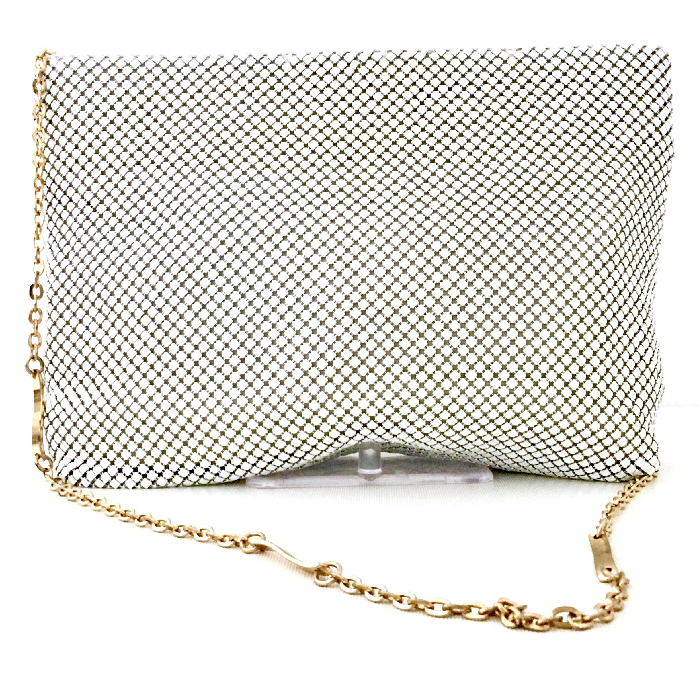1970'S Whiting & Davis White Metal Mesh & Gold Chain Link Shoulder Strap Hand Bag. This rare white metal mesh bag features a lovely gold plate chain link shoulder strap, white leather detail and gold signed charm ornament at zipper closure. This bag