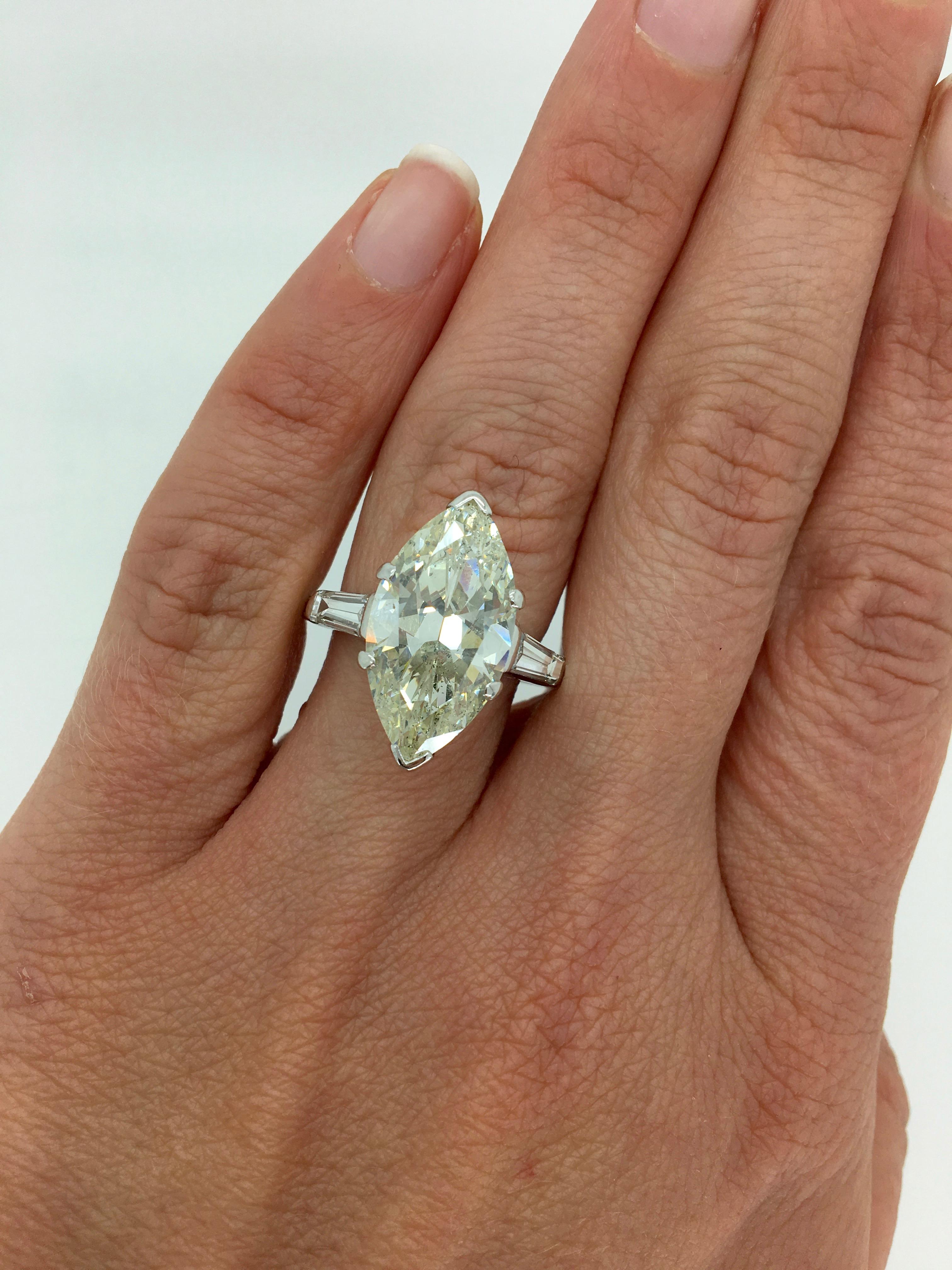 Absolutely Stunning 7.10CT Marquise Cut Diamond Ring With Classic Flanking Tapered Baguette Cut Diamonds.

Center Diamond Carat Weight: Approximately 7.10CT
Center Diamond Cut: Marquise Cut
Center Diamond Color: N-O
Center Diamond Clarity:  I1
Total