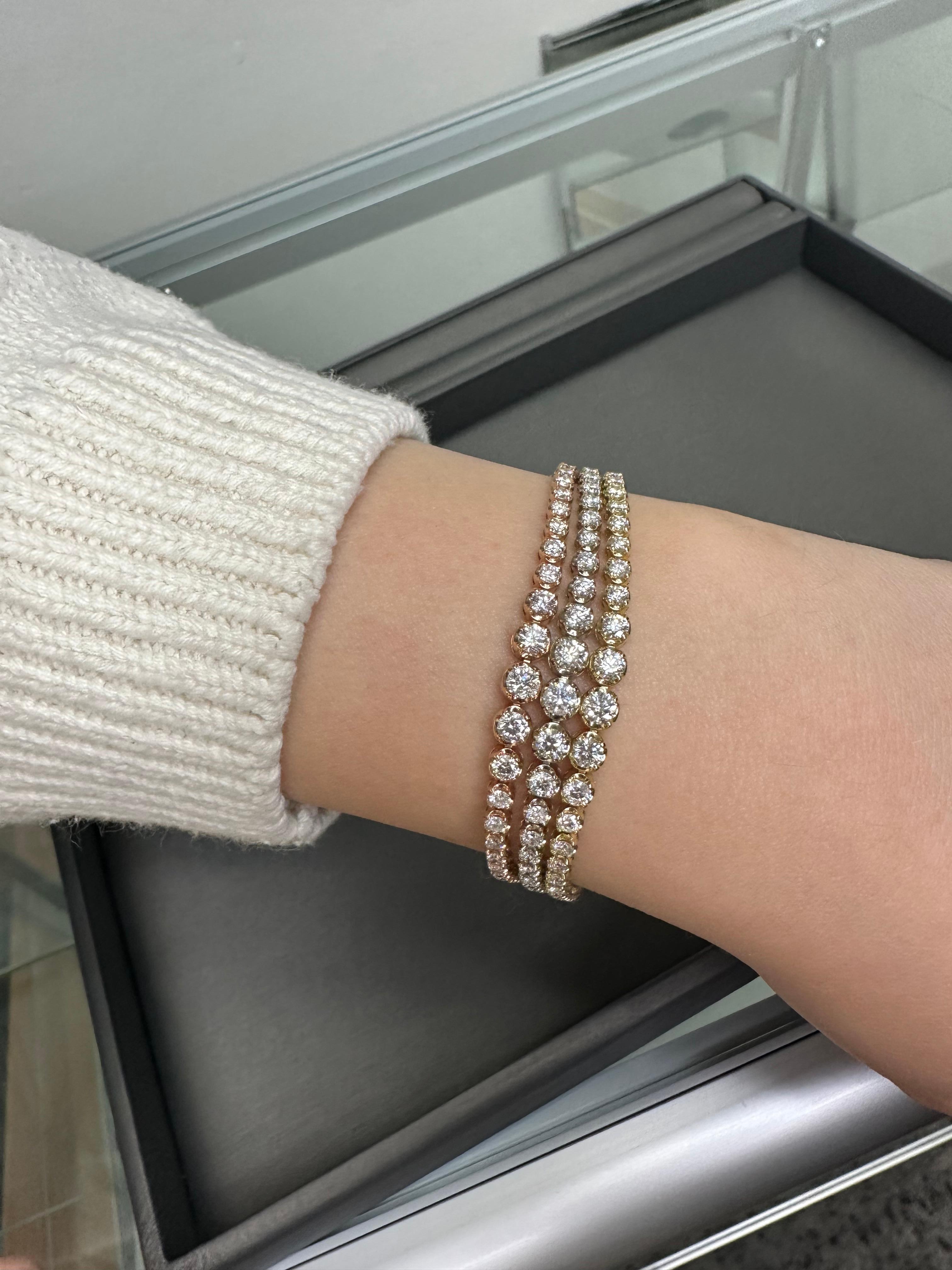 Introducing the breathtaking Triple Row Graduated Diamond Tennis Bracelet by Gem Jewelers Co. is a must-have for any Diamond Jewelry Enthusiast! This Tennis Bracelet boasts three rows of brilliant 7.10 Carat Diamonds in a Graduated setting, but