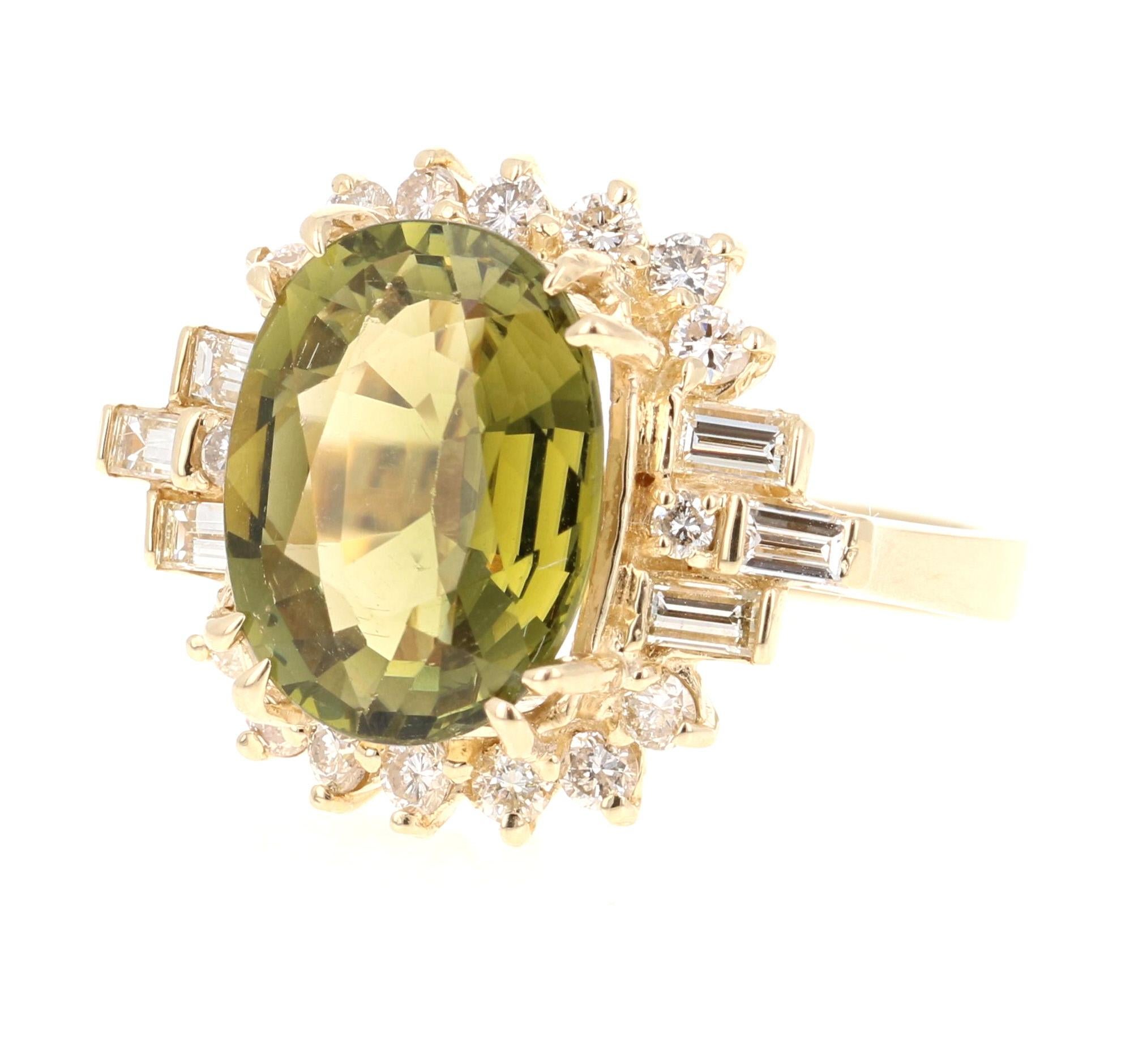 This ring has a mesmerizing Oval Cut Olive Green Tourmaline weighing 5.72 Carats and 16 Round Cut Diamonds weighing 0.62 Carats as well as 6 Baguette Cut Diamonds weighing 0.77 Carats. The total carat weight of the ring is 7.11 Carats. 

The Oval