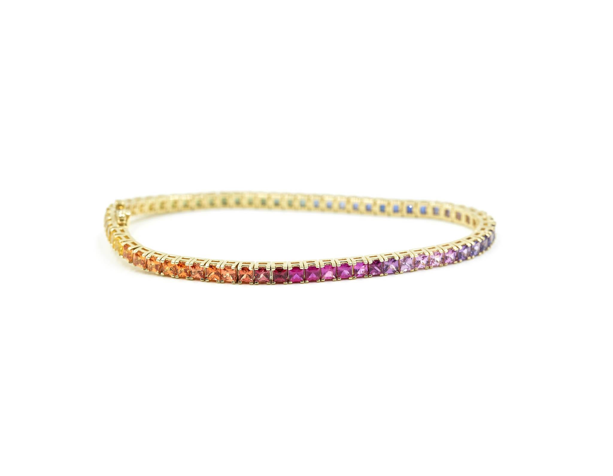 Designer: custom design
Material: 14k yellow gold
Sapphires: princess cut rainbow sapphires = 7.11 carat total weight
Dimensions: the bracelet measures 7-inch long and 1/8-inch wide
Weight: 11.84 grams
