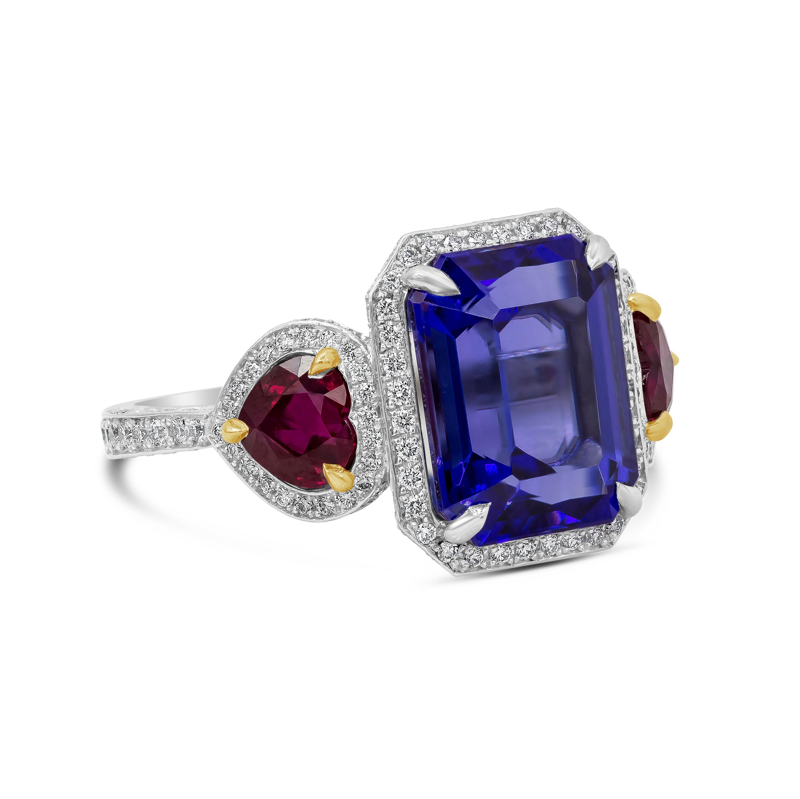 A brilliant design showcasing a purplish-blue emerald cut tanzanite, flanked by heart-shaped rubies on either side. Set in a diamond encrusted surmount made in platinum and accented with yellow gold. Rubies weigh 1.68 carats; diamonds weigh 1.21