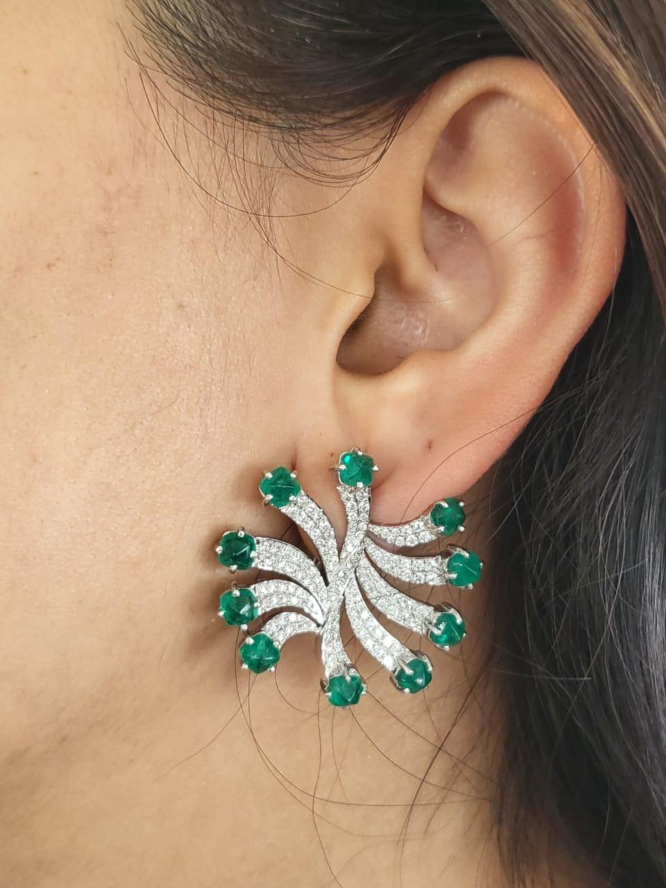 A very gorgeous and one of a kind, Art Deco style, Emerald Stud Earrings set in 18K White Gold & Diamonds. The weight of the Emerald is 7.11 carats. The sugarloaf cabochon Emeralds are completely natural, without any treatment and is of Columbian