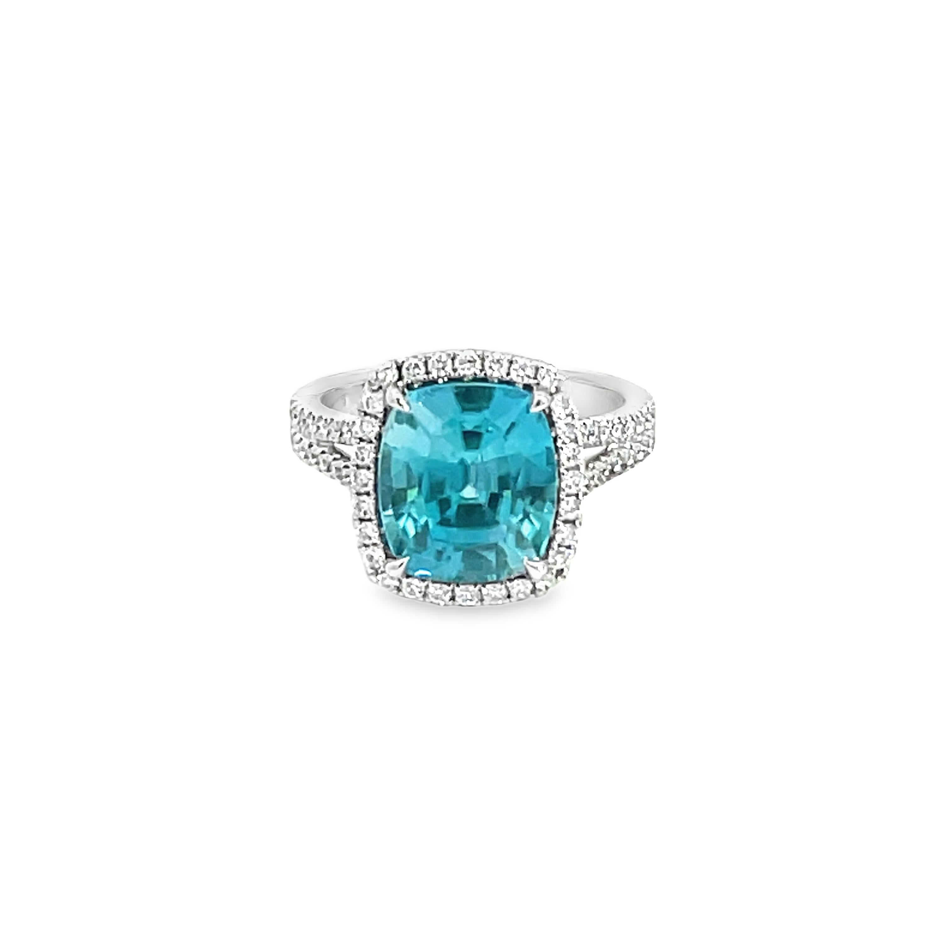 This stunning Cocktail Ring features a beautiful 7.13 Carat Cushion Blue Zircon with a Diamond Halo, on a Double Diamond Shank. This Ring is set in 18K White Gold. 
Total Diamond Weight = 0.43 carats. Ring Size is 6 1/2.