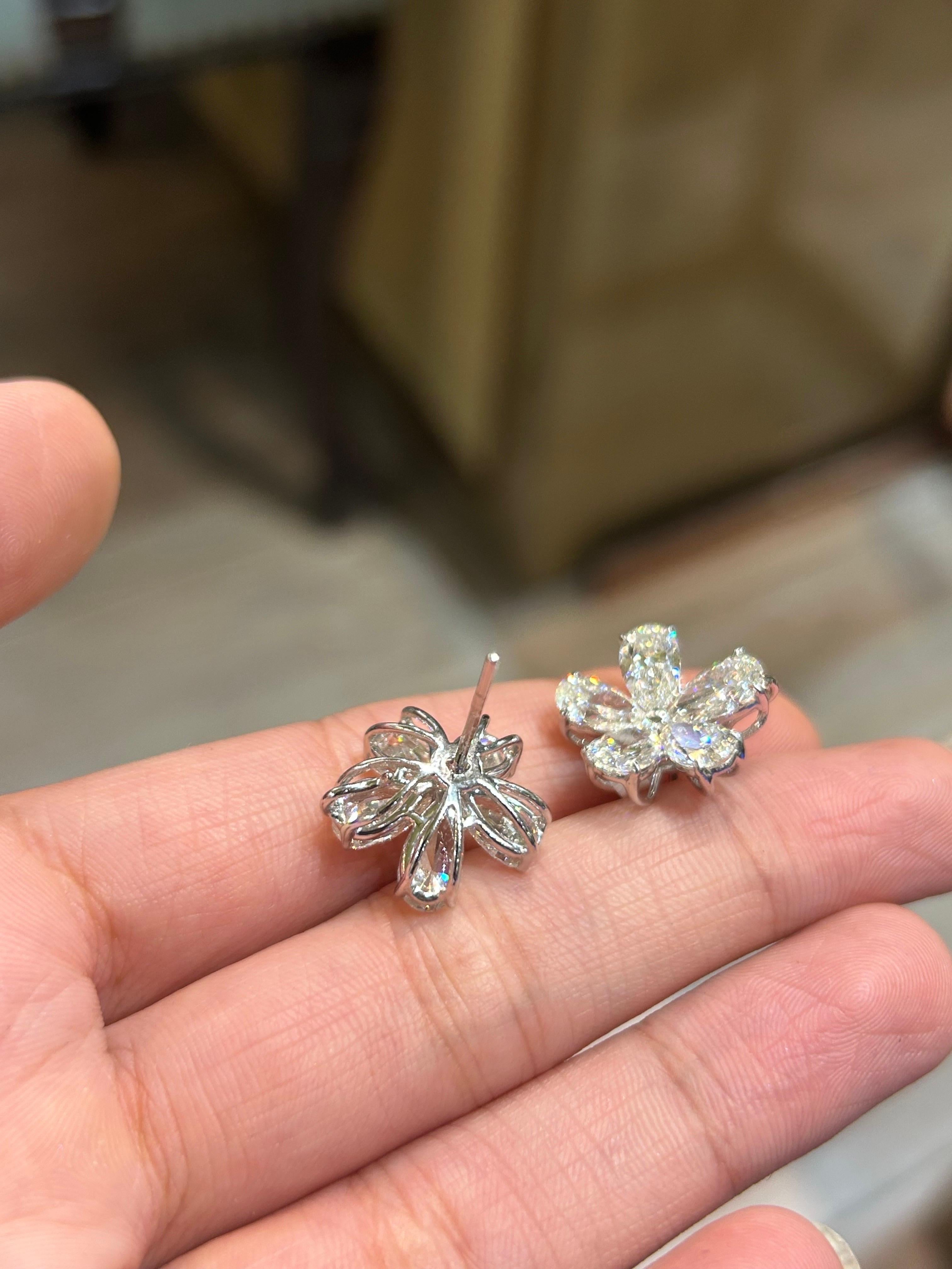 A stunning pair of VVS/VS quality G/H color pear shape diamond earrings, each weighing around 0.7 carats. Set in solid 18K White Gold. Comes with a push-pull backing. 