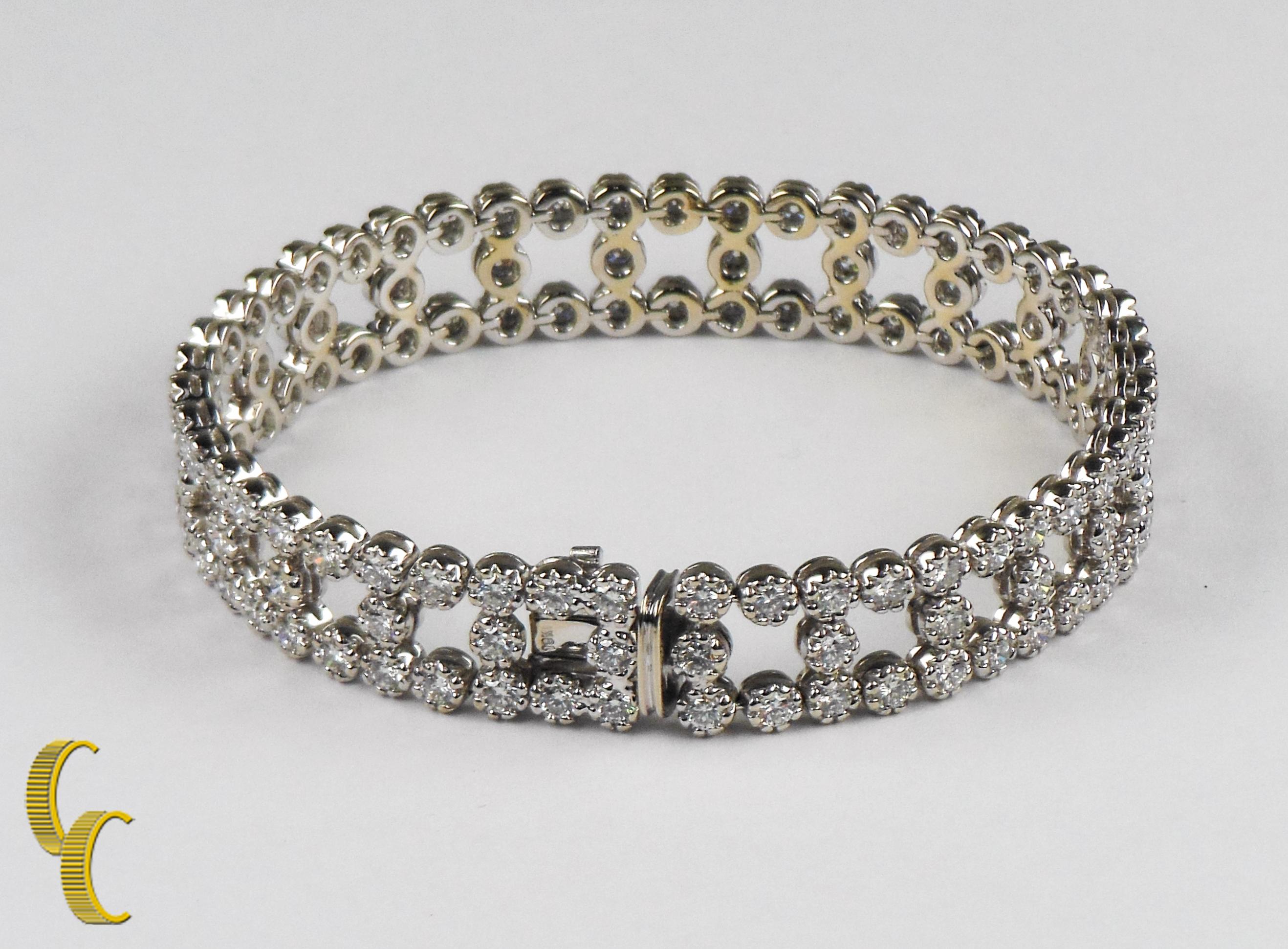 Beautiful Diamond Bracelet!
Great Gift!
7.15 Carat Total Weight
Total Weight of Bracelet - 32.34 g
The Bracelet Measures 11.57 mm wide and 3.50 mm thick
One Stamped 18k white gold lady's combination cast and assembled diamond bracelet with a box