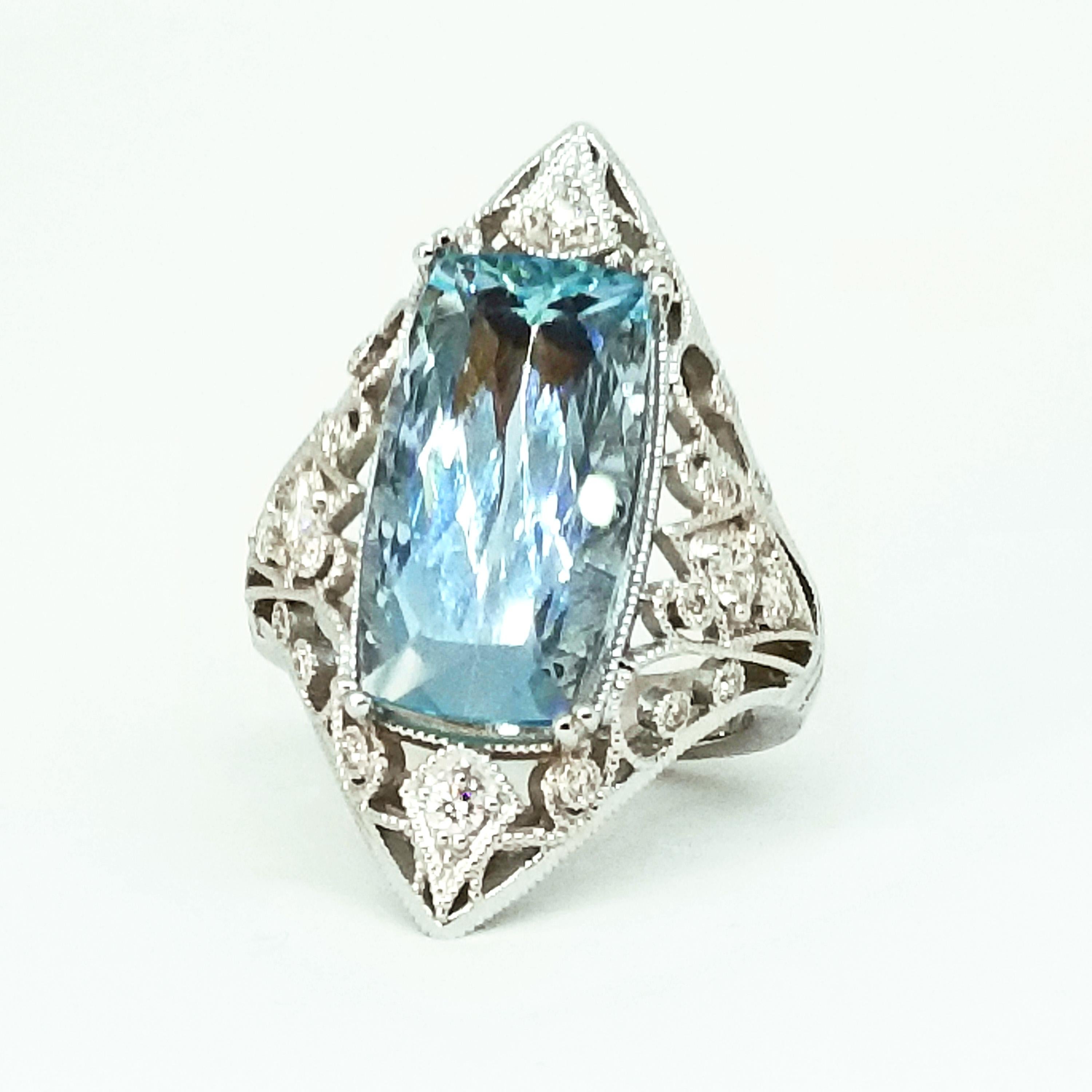 One of a Kind Statement Cocktail Ring in 18K White Gold with Hand Millegrain and Filigree Detail is Designed and Crafted by Tom Castor and features a faceted 7.15 Carat Very Fine Edwardian Cut Brazilian Aquamarine of Gem Clarity. Also set in the